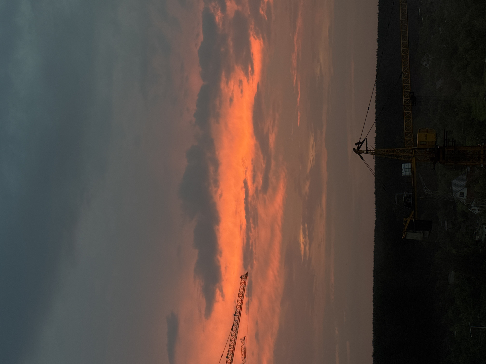 Cranes and apartment towers at sunset in Izhevsk