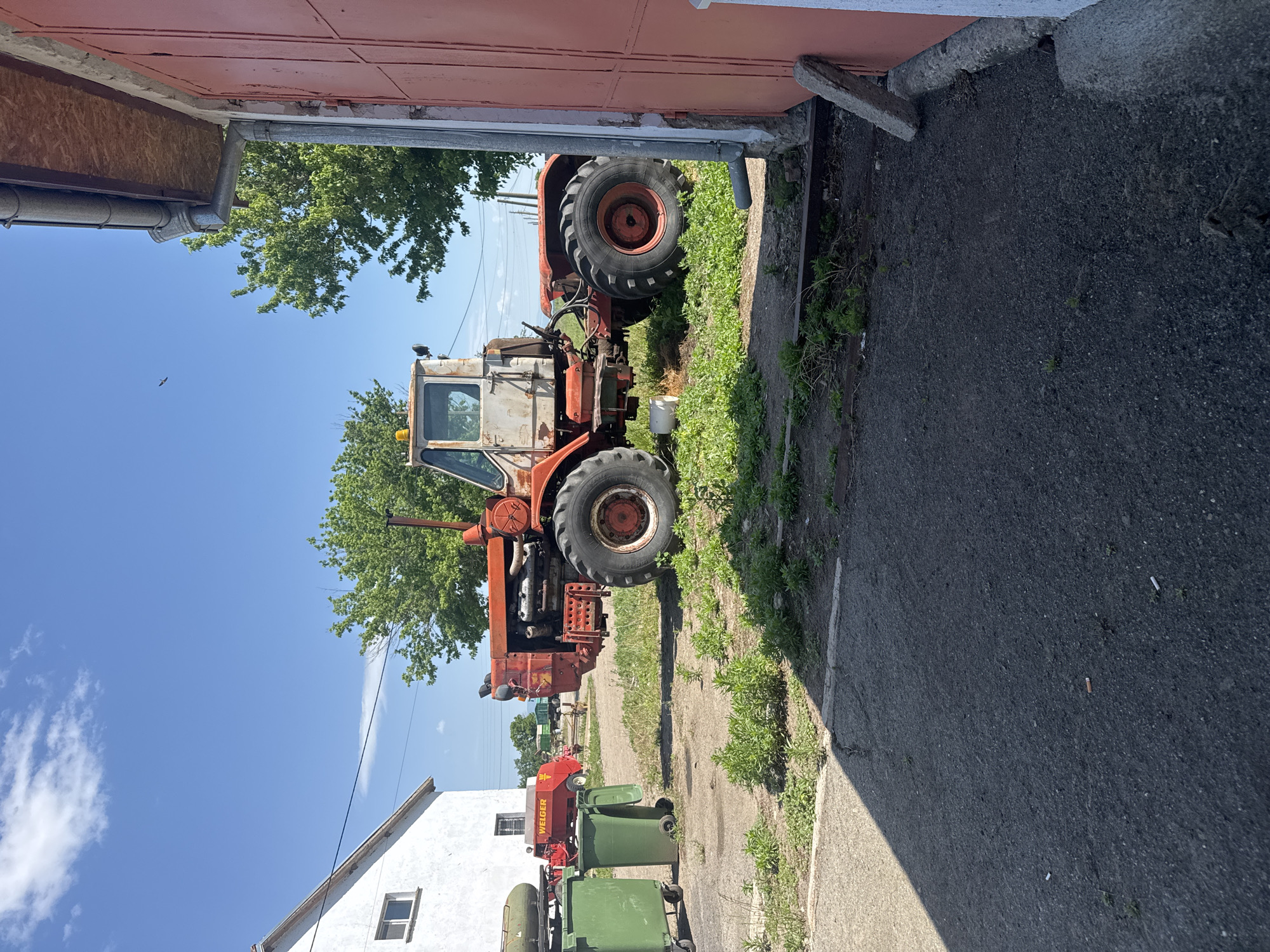 Farm machinery parked in rural Bulgarian village storage area