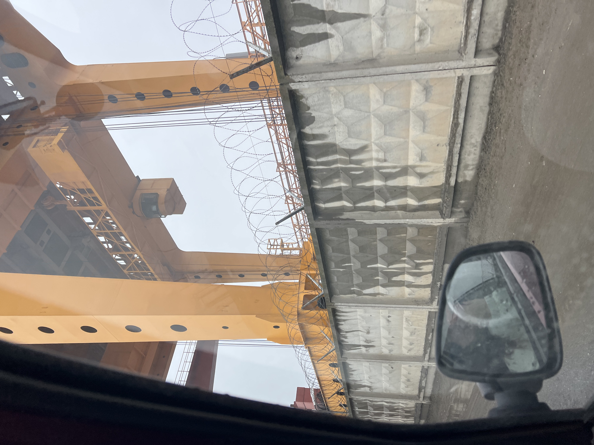 Industrial scene with yellow crane documented in Noviy, Russia