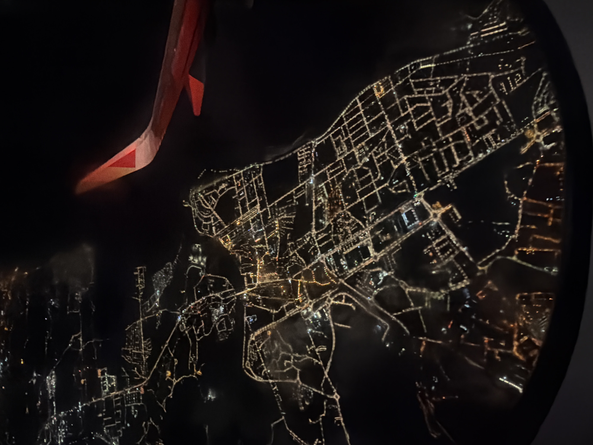 Aerial nighttime view of illuminated Lisbon captured from airplane