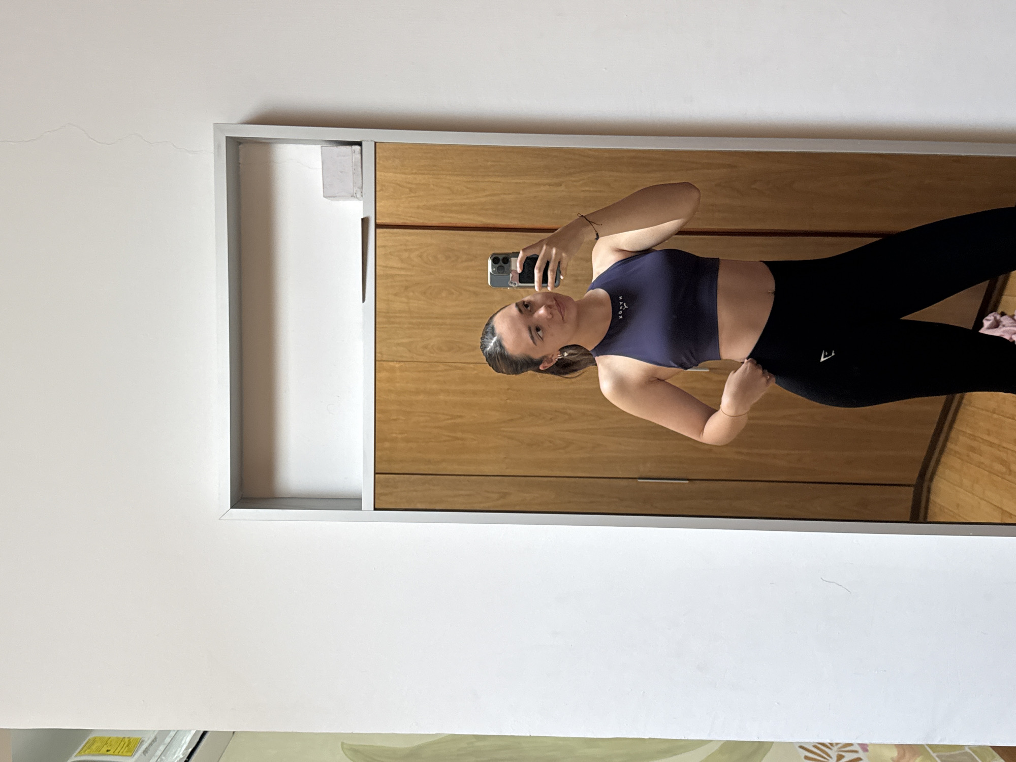 Woman takes mirror selfie in workout clothes in Mexico