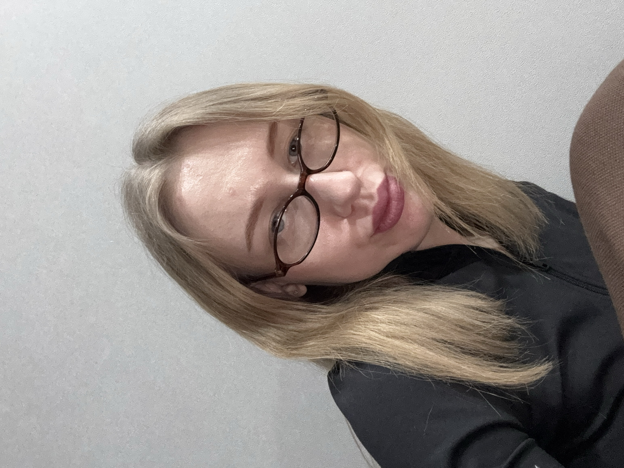 Woman takes multiple selfies indoors in Kuleshovka, Russia