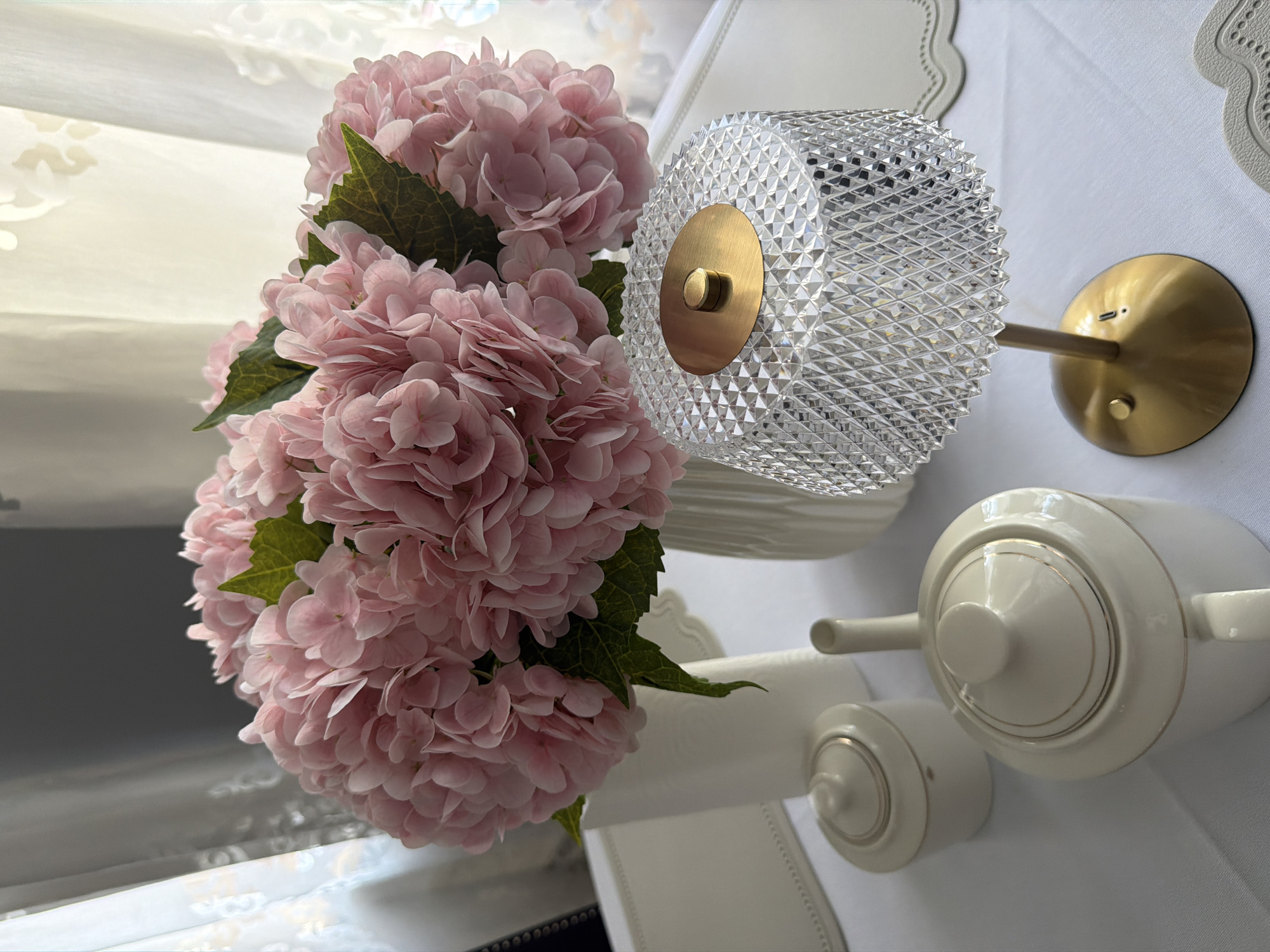 Pink hydrangeas and crystal objects arranged on table in Khimki