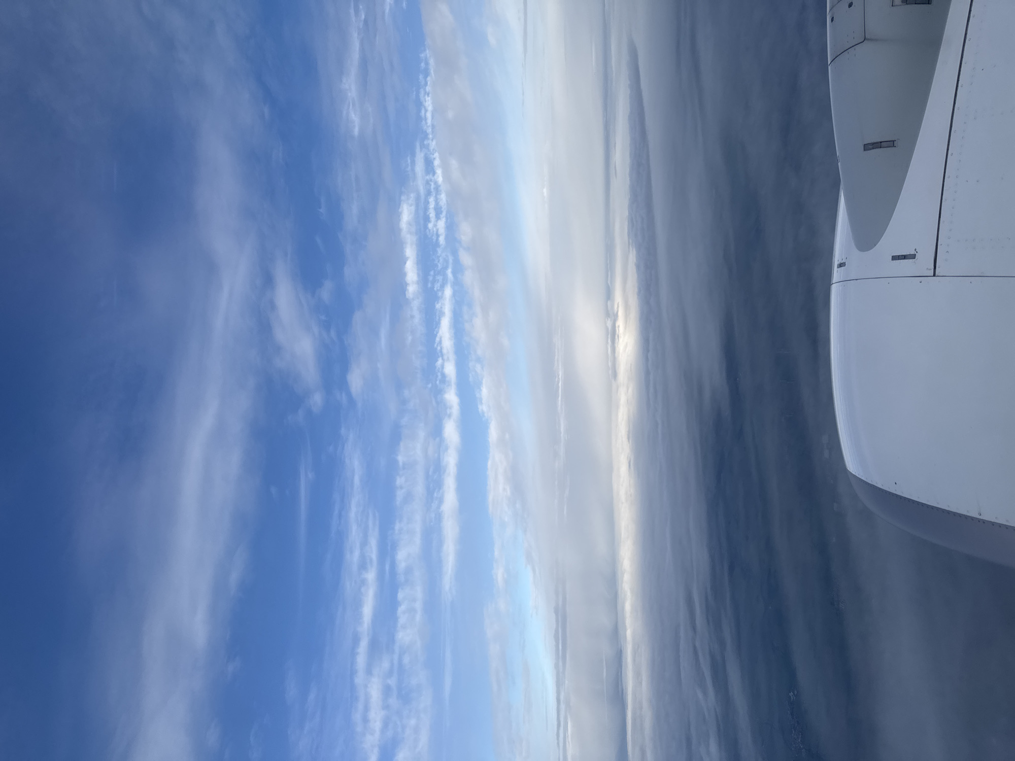 Passenger captures aerial view of clouds from airplane window