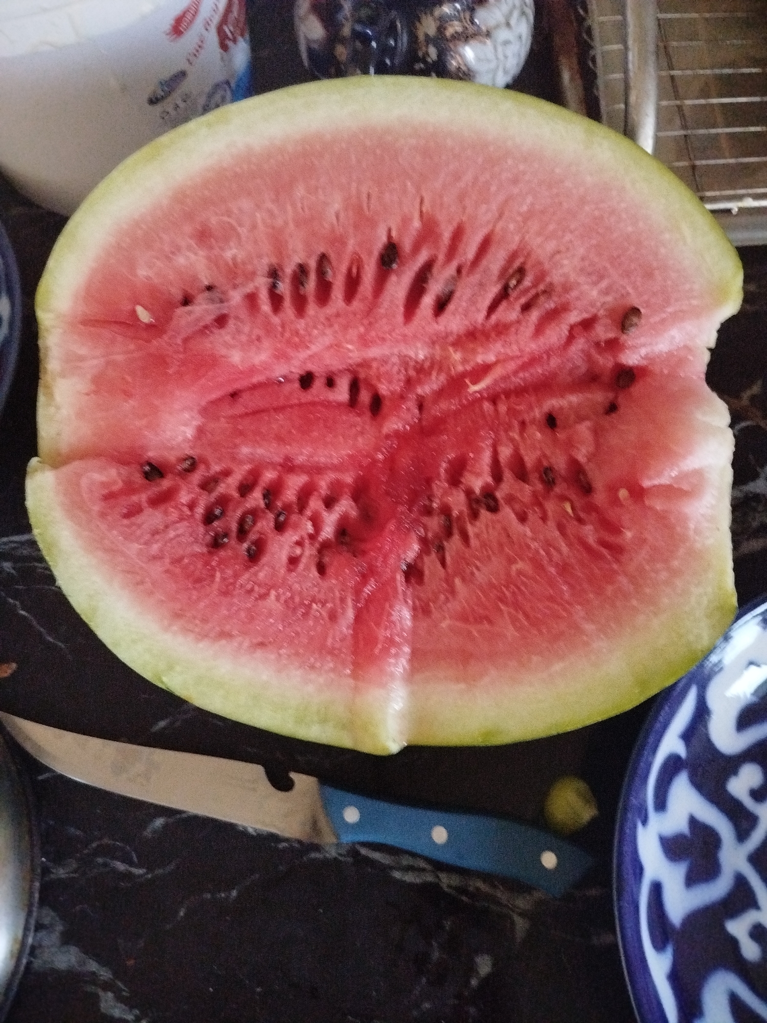 Freshly cut watermelon and honeydew on a dark surface