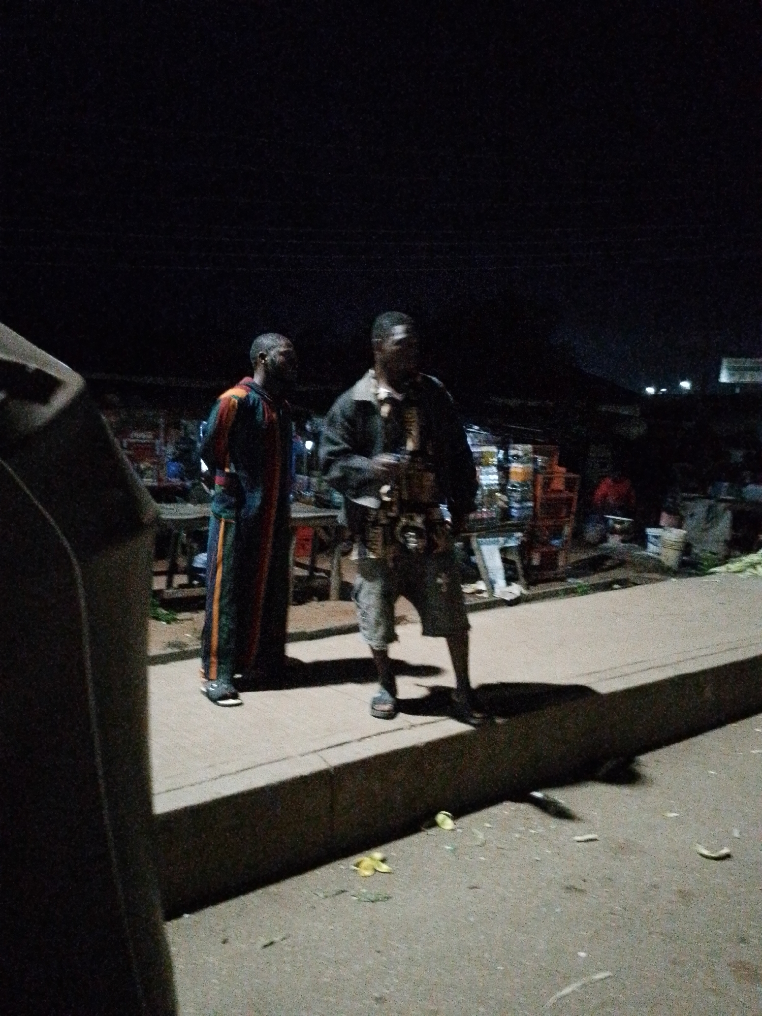 Late night street life around Bukuru's keke napep stands and corn vendors