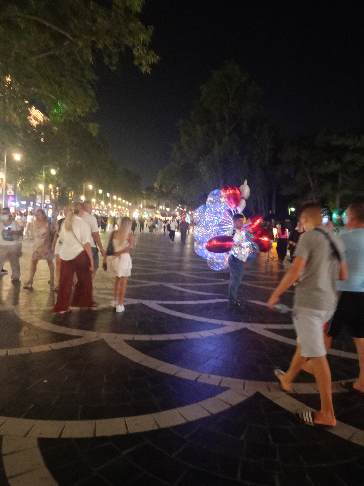 Cat lounging on a patterned pedestrian walkway at night