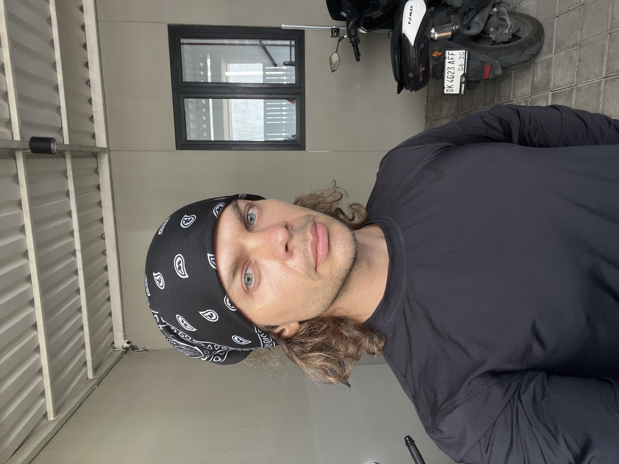 Man takes selfie with motorcycle in Mengwi, Indonesia
