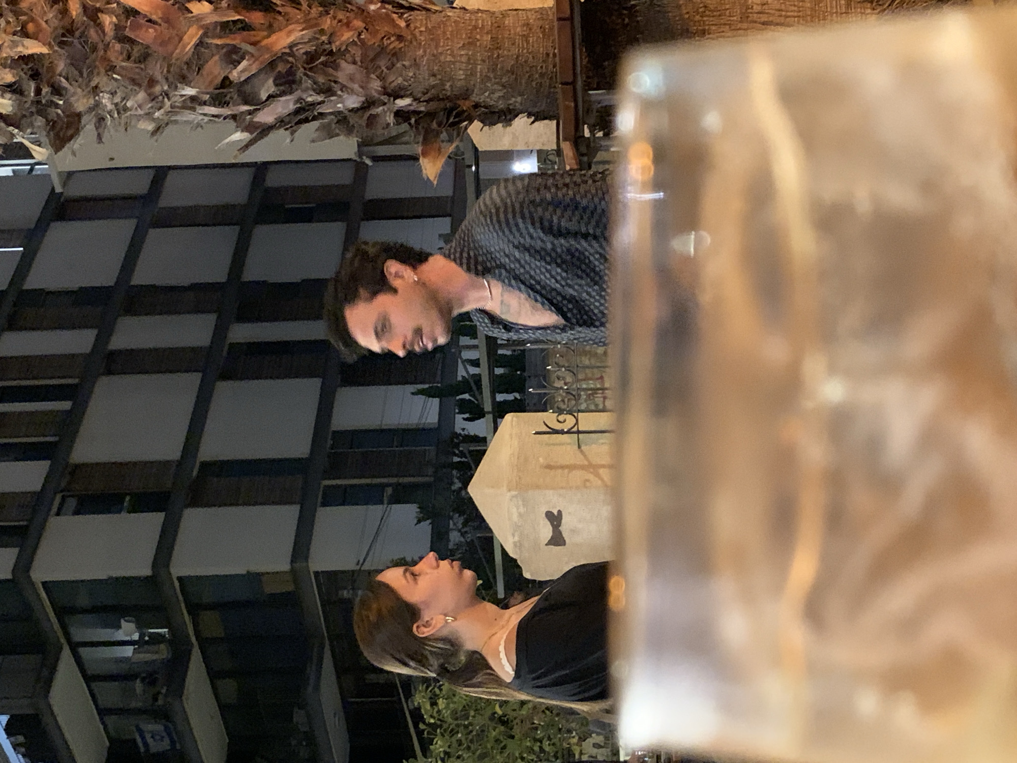 Nighttime conversation observed between couple in Tel-Aviv outdoor setting