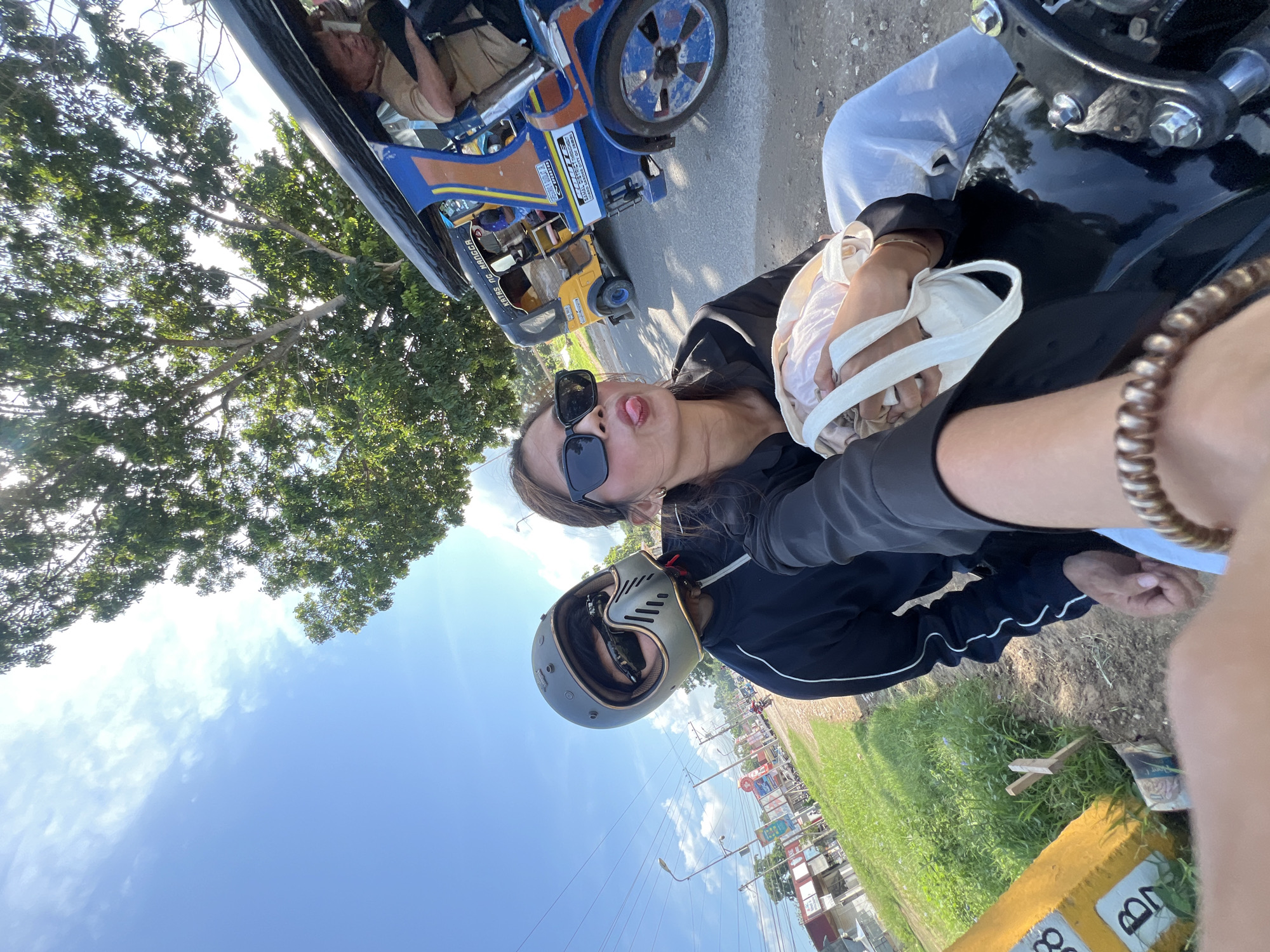 Young travelers document motorcycle road trip with selfies in Samal