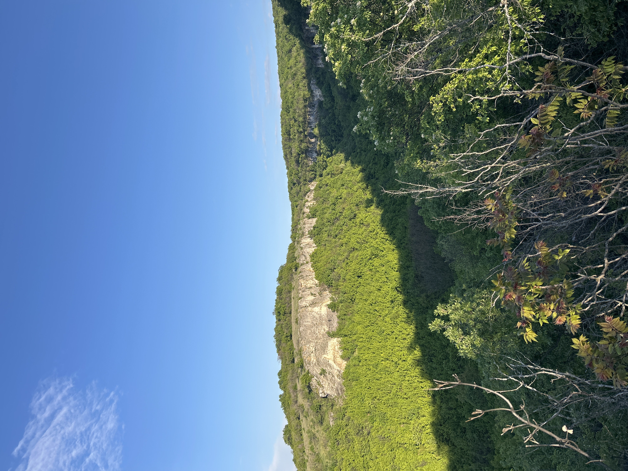 Clear skies over green cliffs documented in Krushuna, Bulgaria