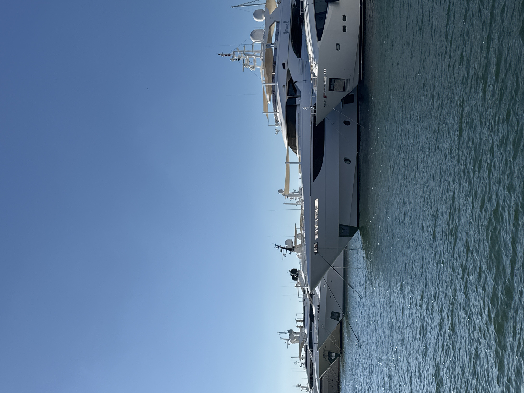 Afternoon at a Greek marina: yachts, naval ships, and ice cream
