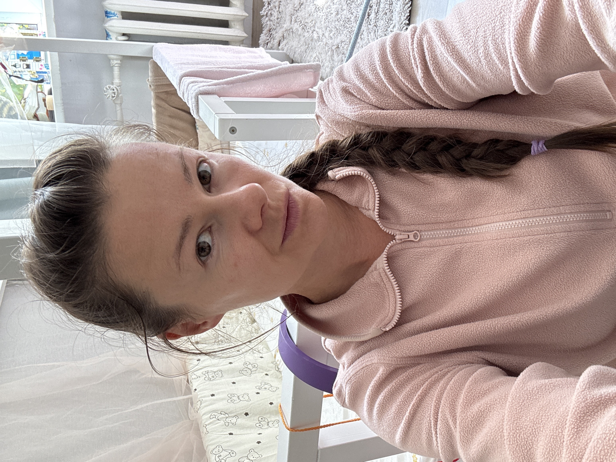 Indoor moment in a Riga home, pink fleece and nursery backdrop