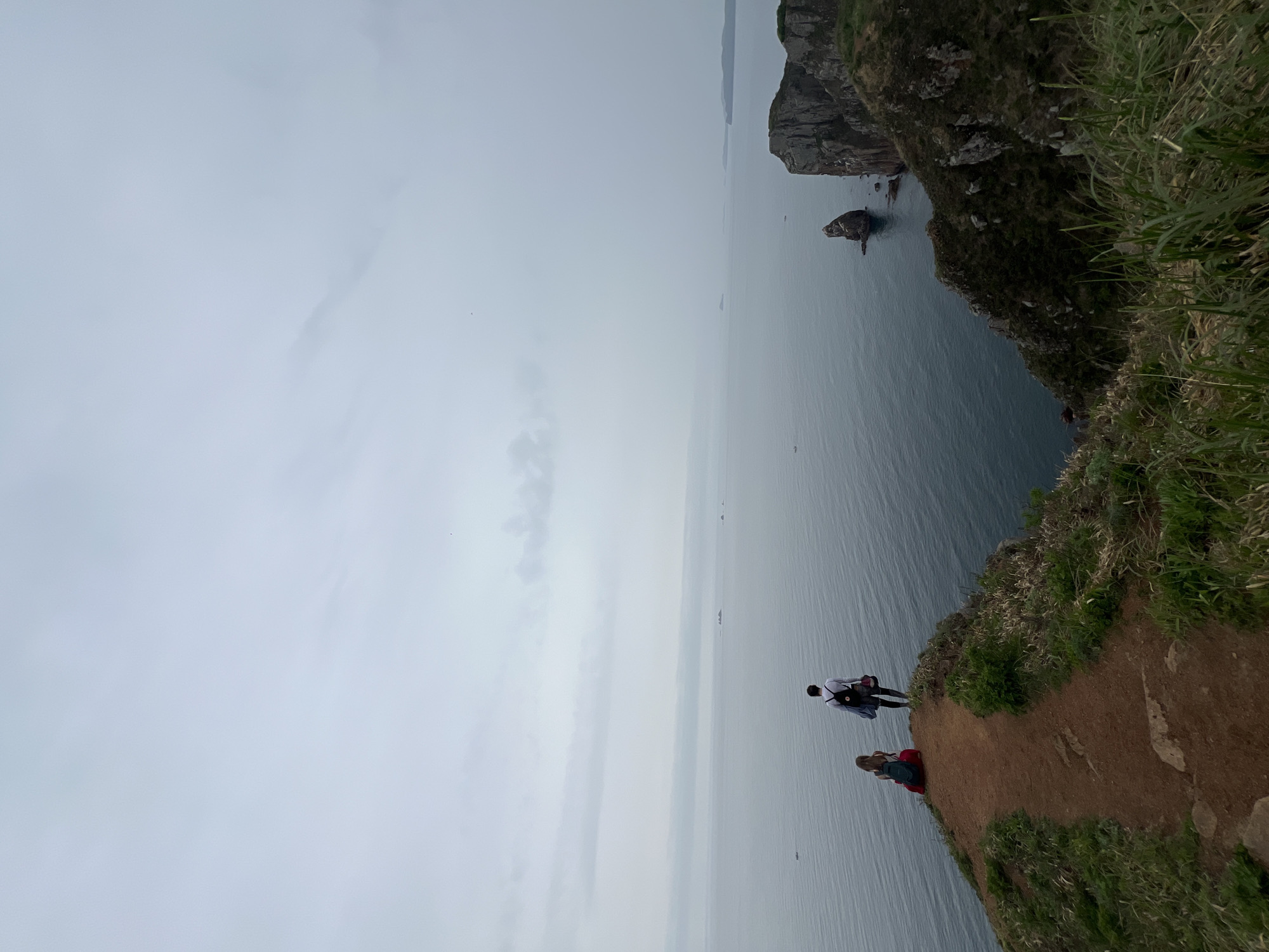 Morning hikers explore cliffs and forests on Russkiy Island