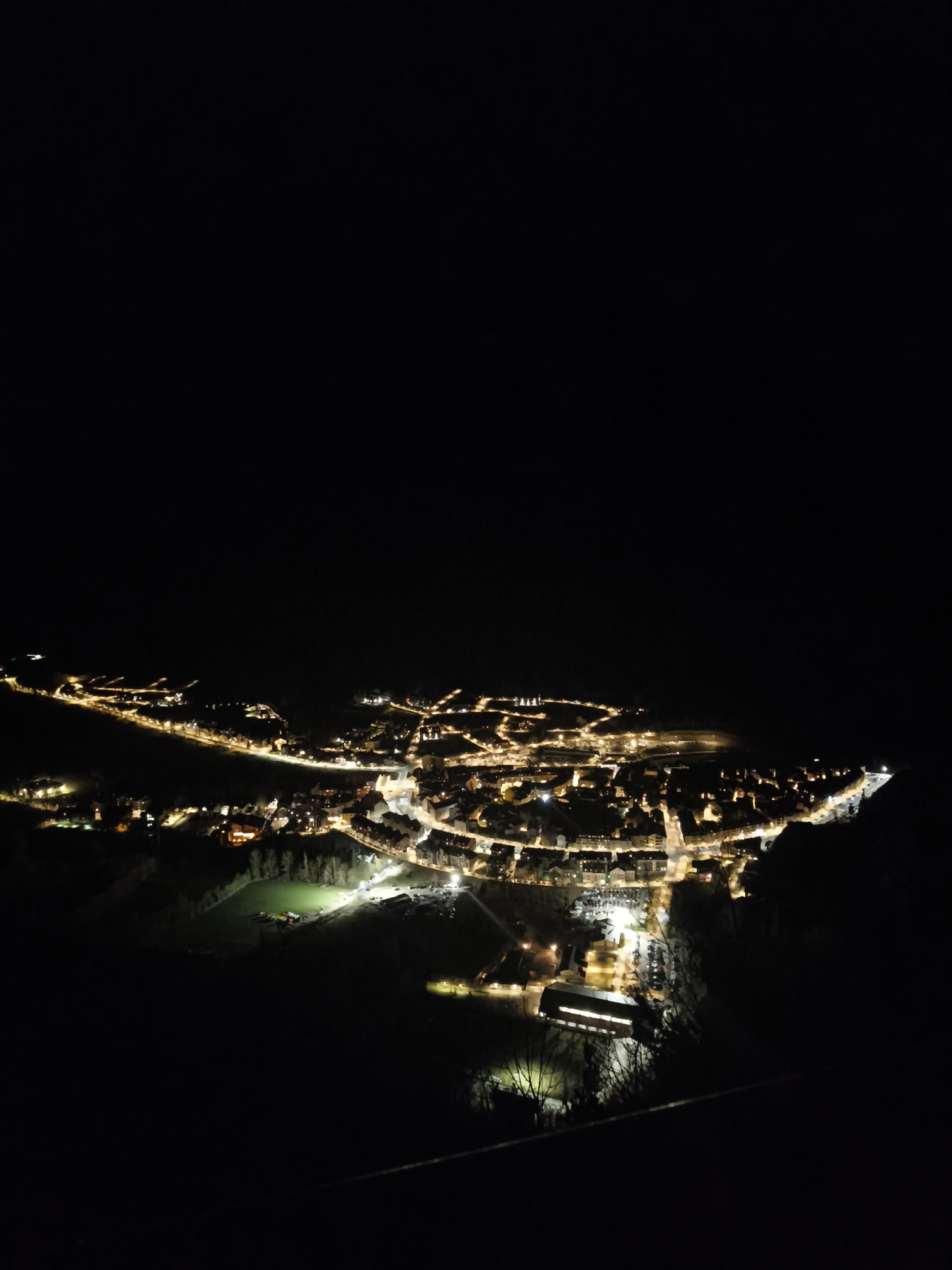 Aerial night view captured of illuminated Benasque, Spain