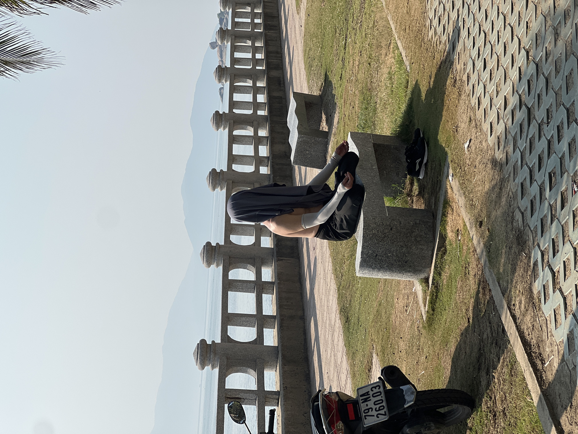 Person meditates on coastal bench in Nha Trang, Vietnam