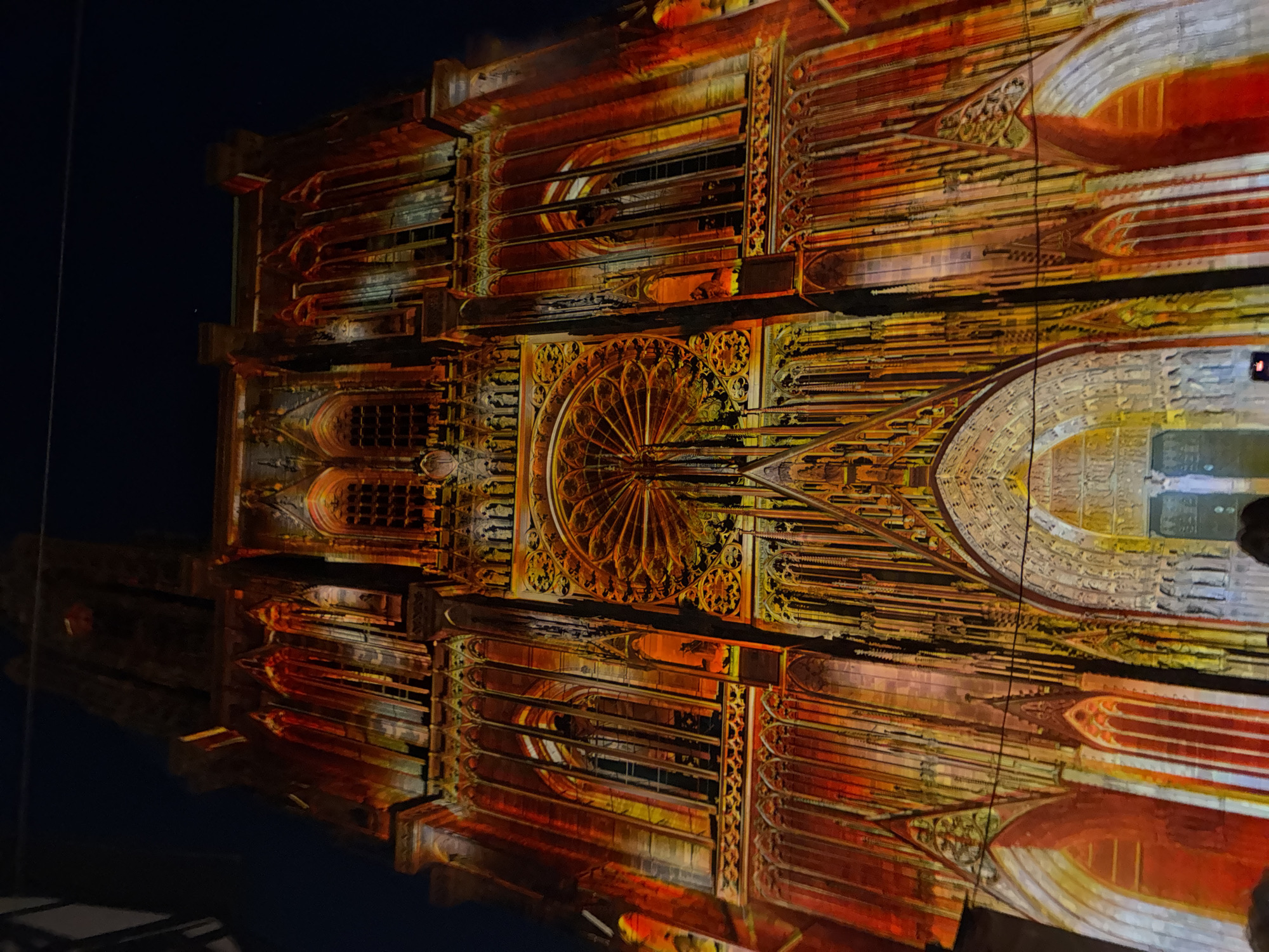 Gothic cathedral lit up by vivid nighttime projection show