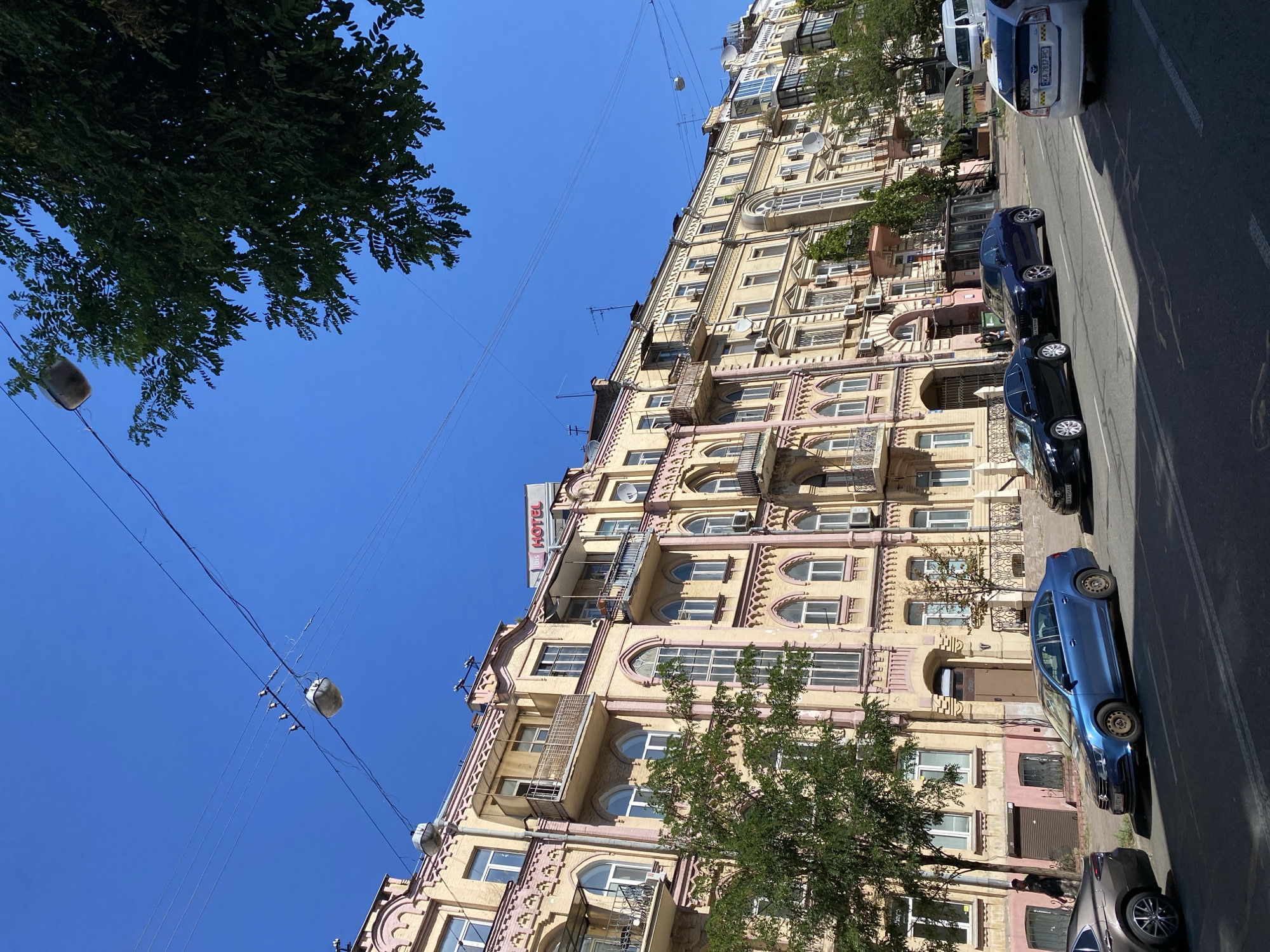 Street-level views of ornate urban buildings and a busy city road
