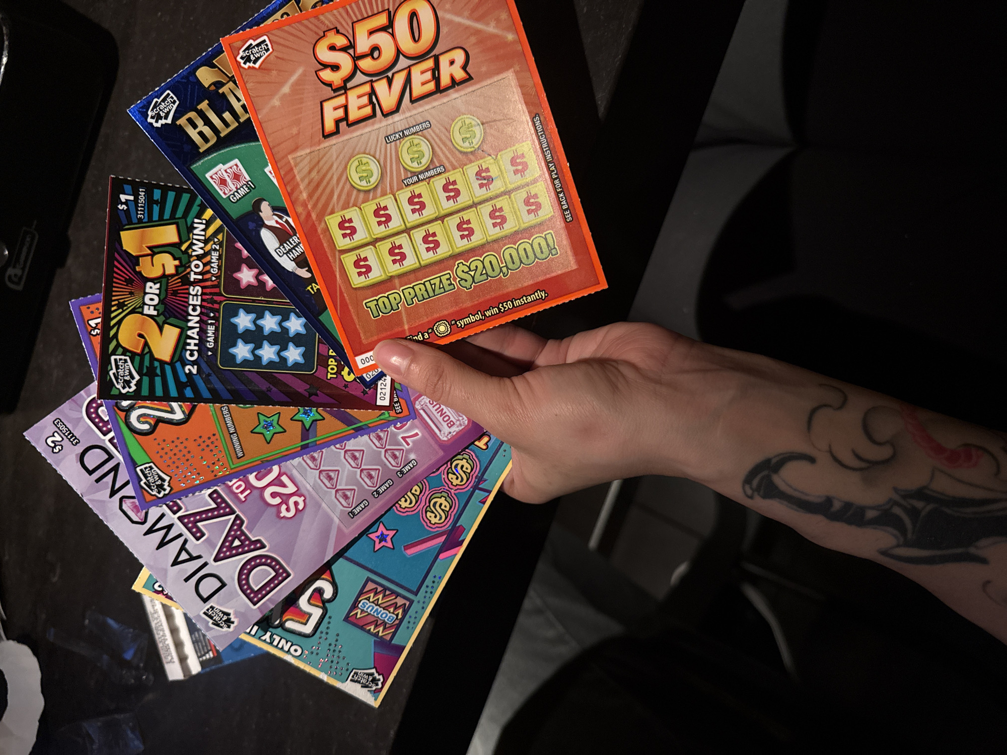 Person holds multiple lottery scratch-off tickets in North Vancouver