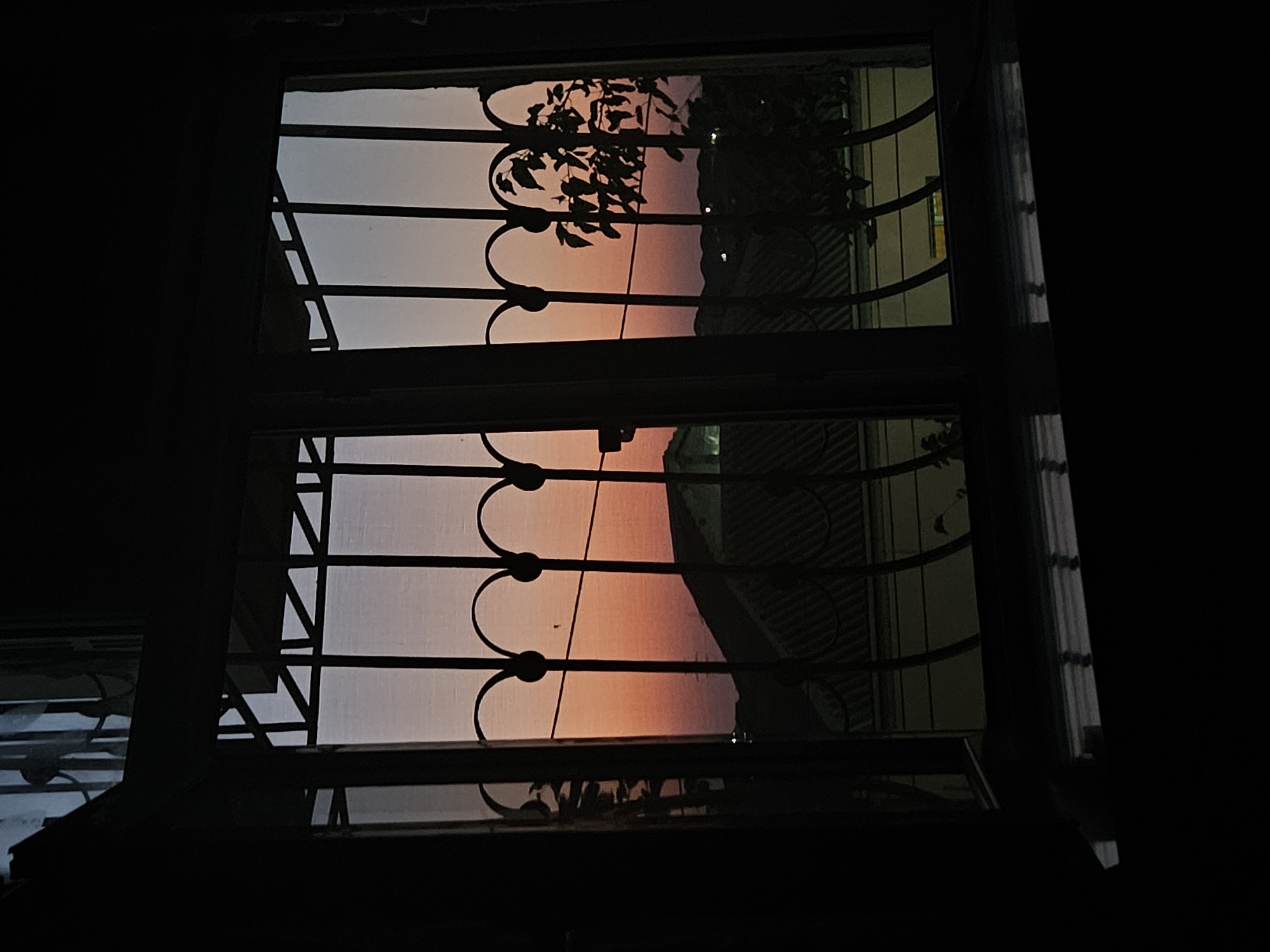 Inside a decorated home as dusk falls outside