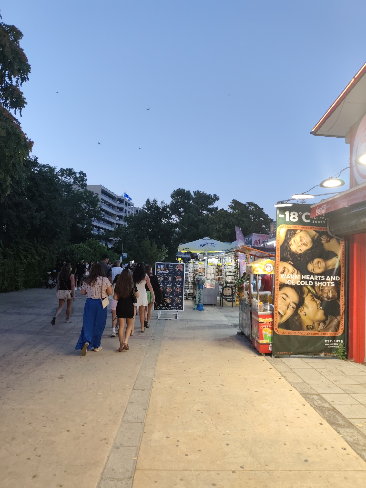 Nesebar's tourist promenade buzzing with market stalls and evening crowds