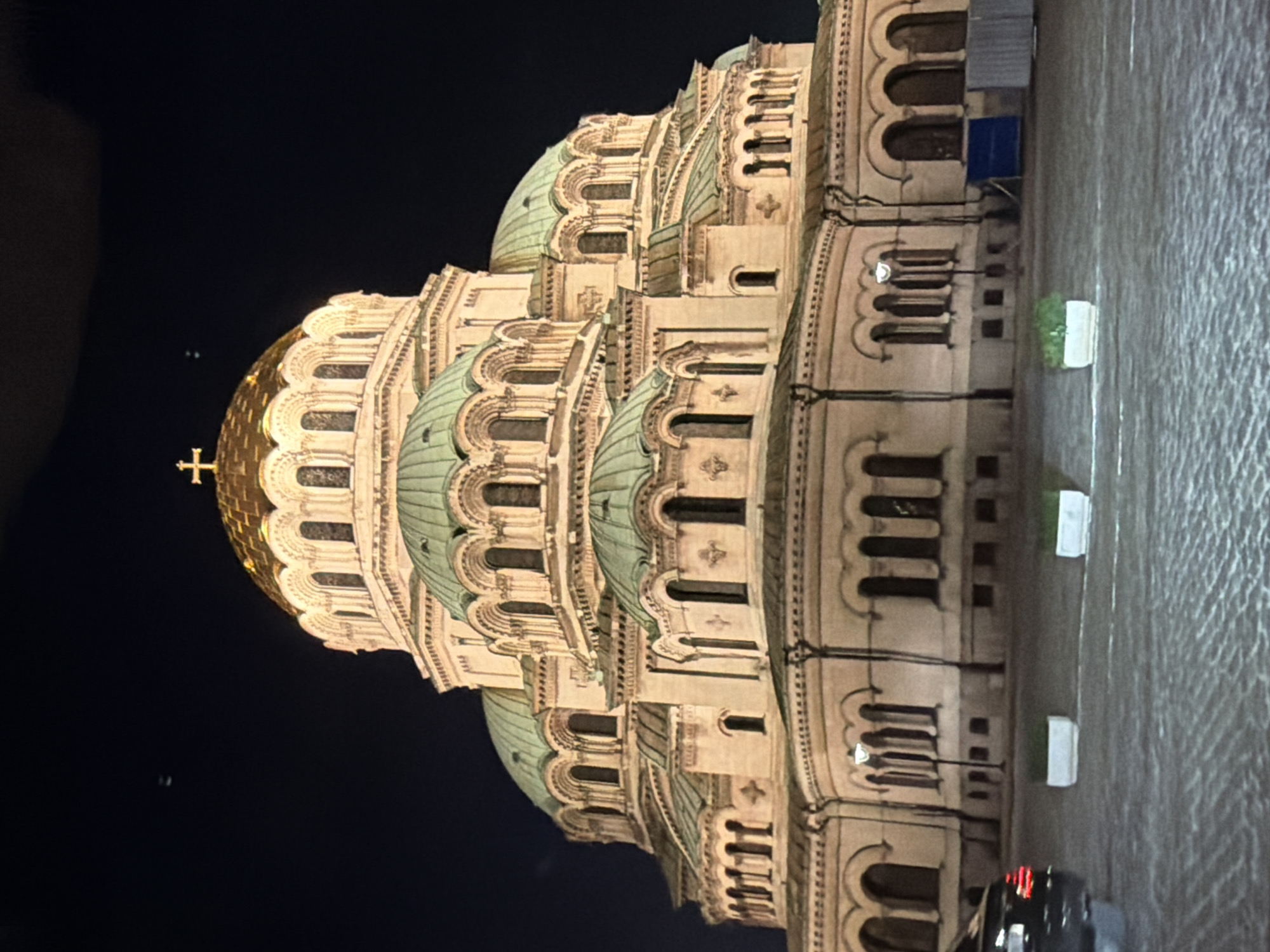 Illuminated cathedral observed at night with ornate architecture