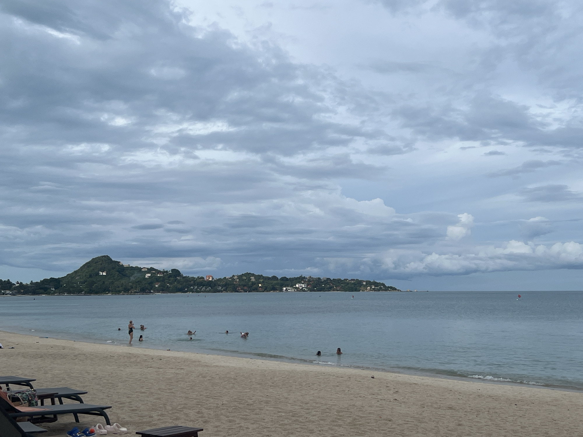 Calm beach day at Baan Lamai under cloudy skies