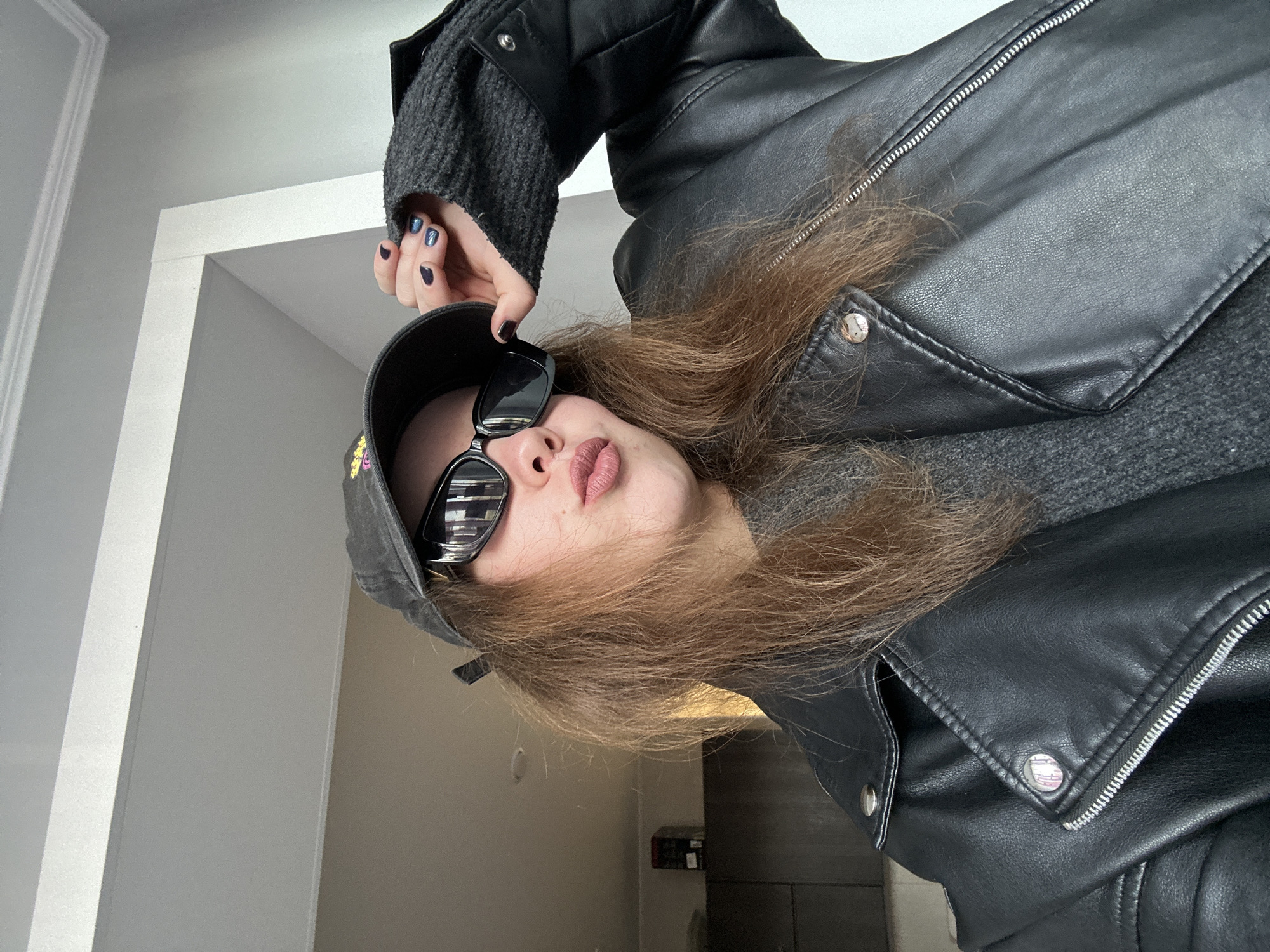 Woman takes selfies in black outfit in Krasnoyarsk apartment