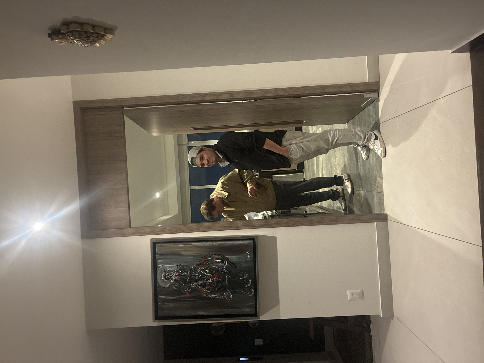 Two men reflected in hallway mirror in Mexico