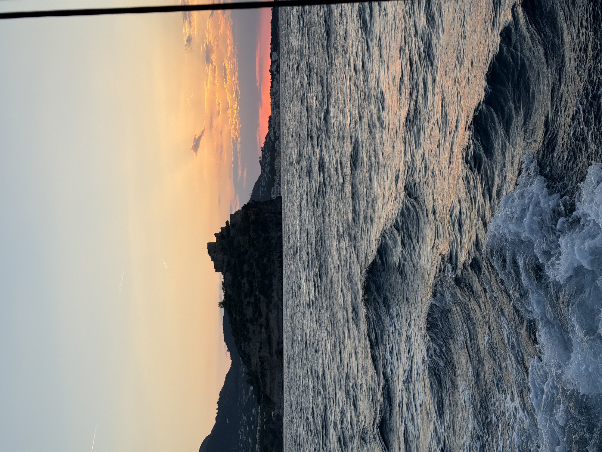 Sunset captured along Ischia coastline showing dusky sky silhouettes