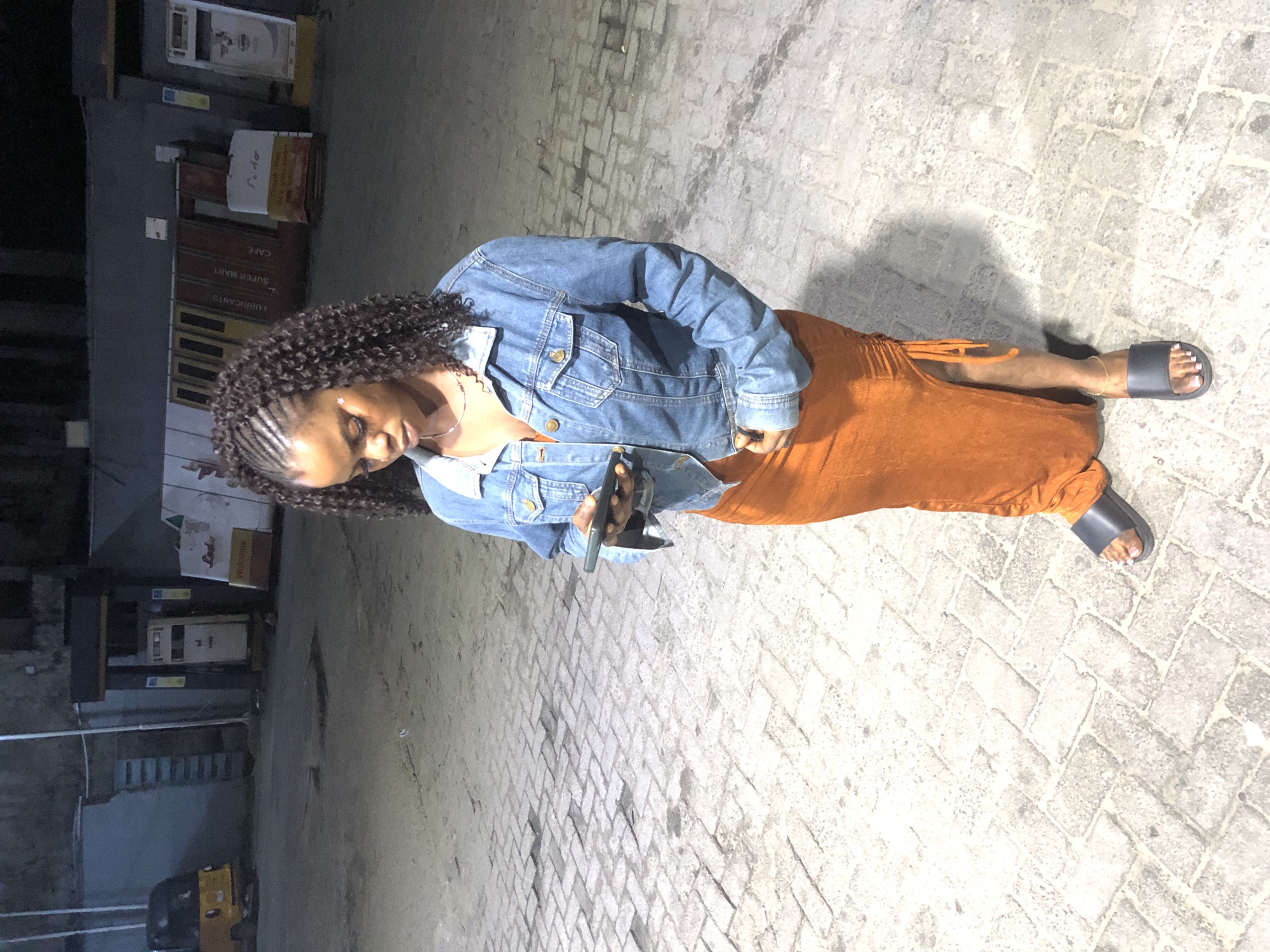 Night street scene in Ado, Nigeria, with fashion details.