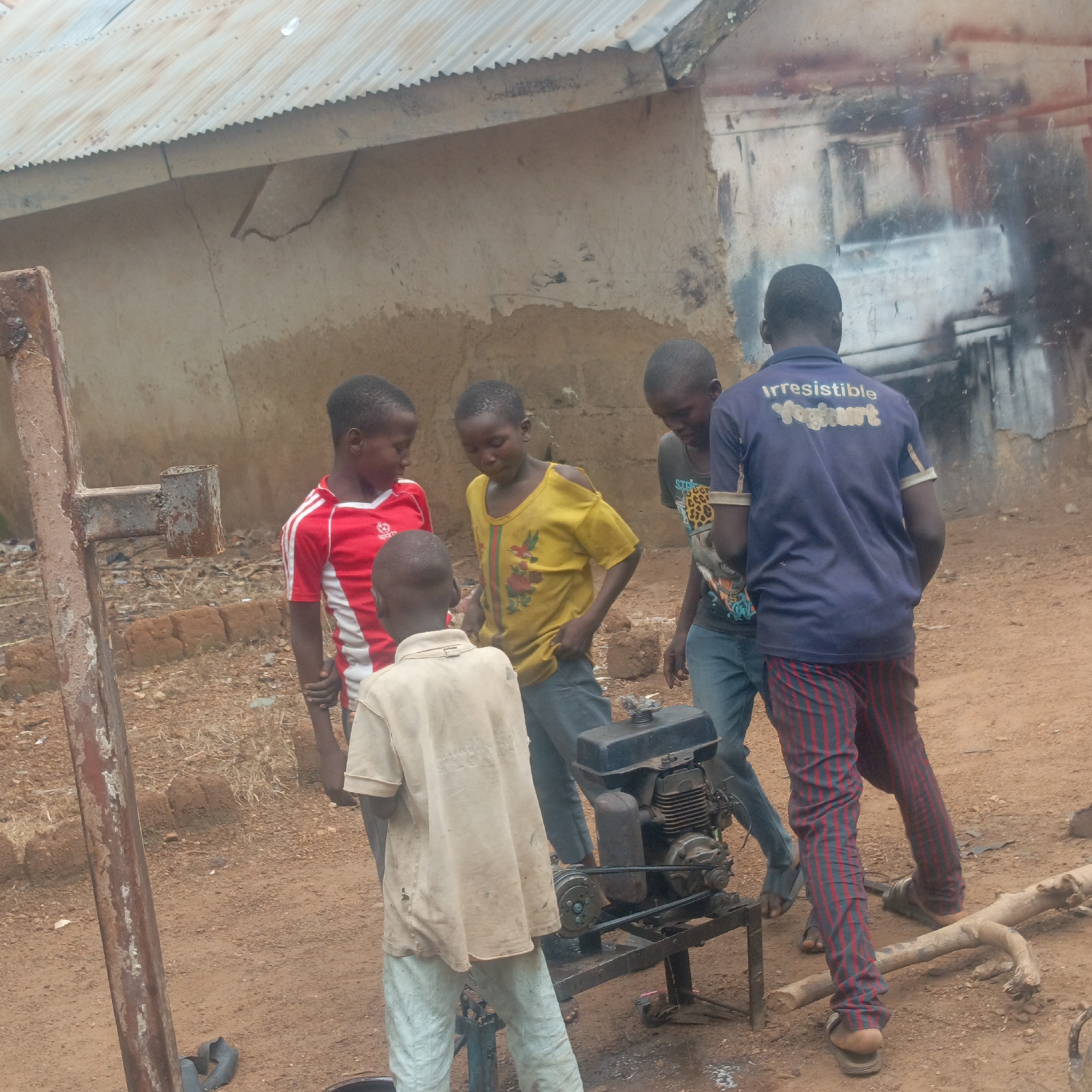 Kids tinkering with a small engine in Akwanga, Nigeria