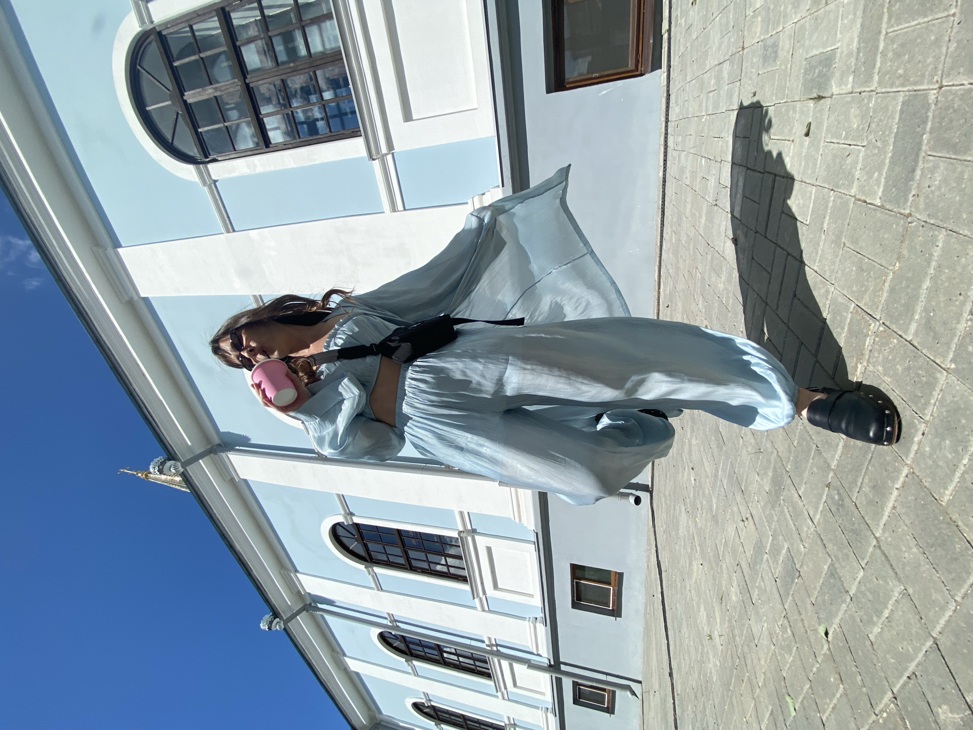 Morning moments: Woman in blue, cat indoors in Votkinsk