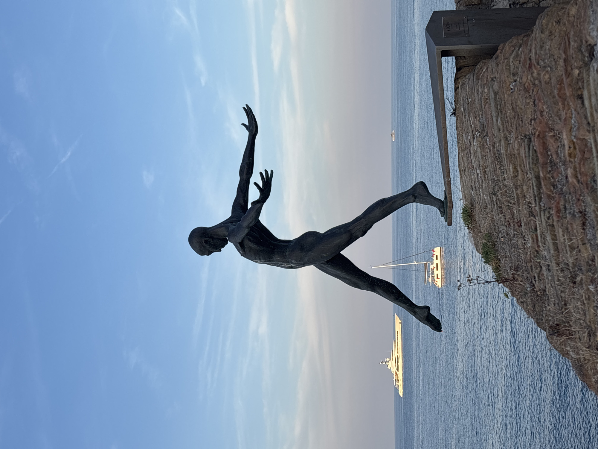 Bronze figure poised on a sea wall in Antibes
