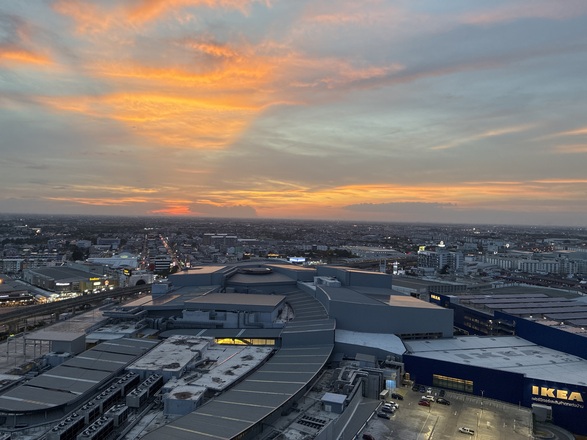 Dusk aerials and casual personal moments in suburban Bangkok