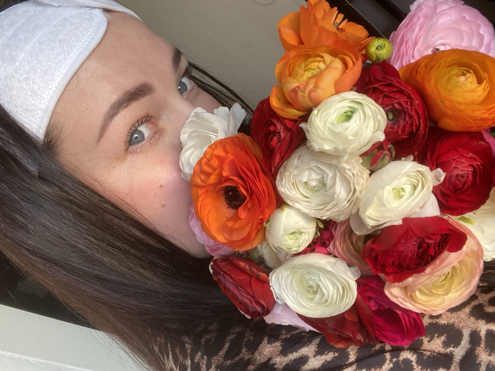 Woman poses with ranunculus bouquets during Sochi photo session