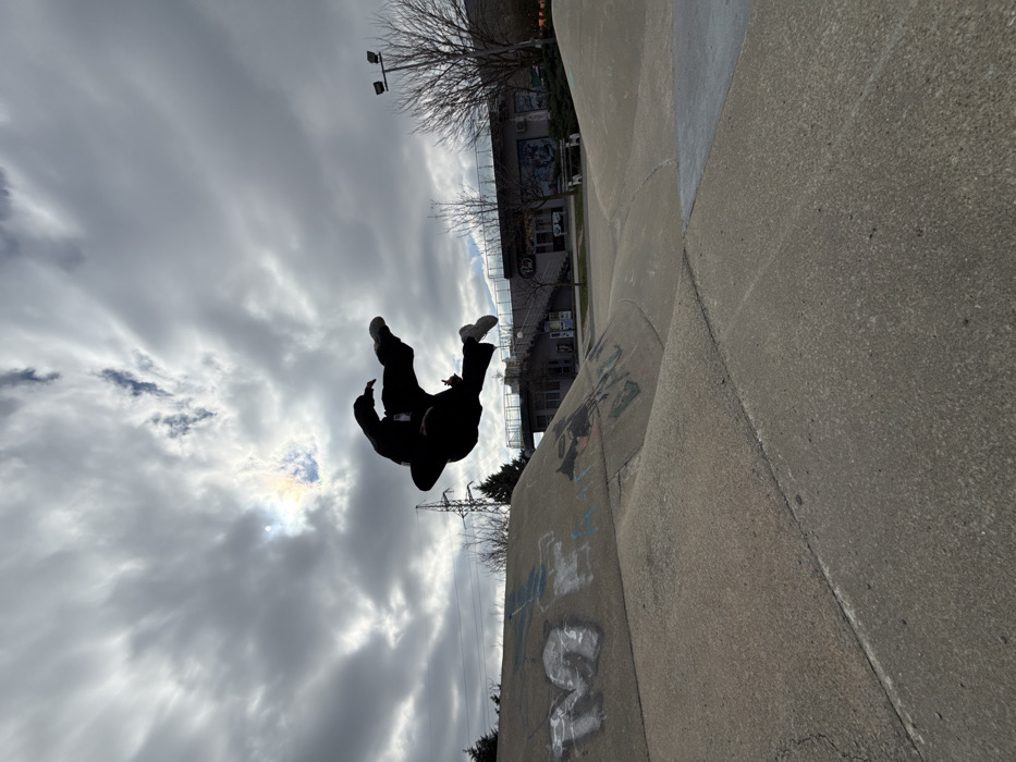 Skateboarder performs backflip at Shumen park