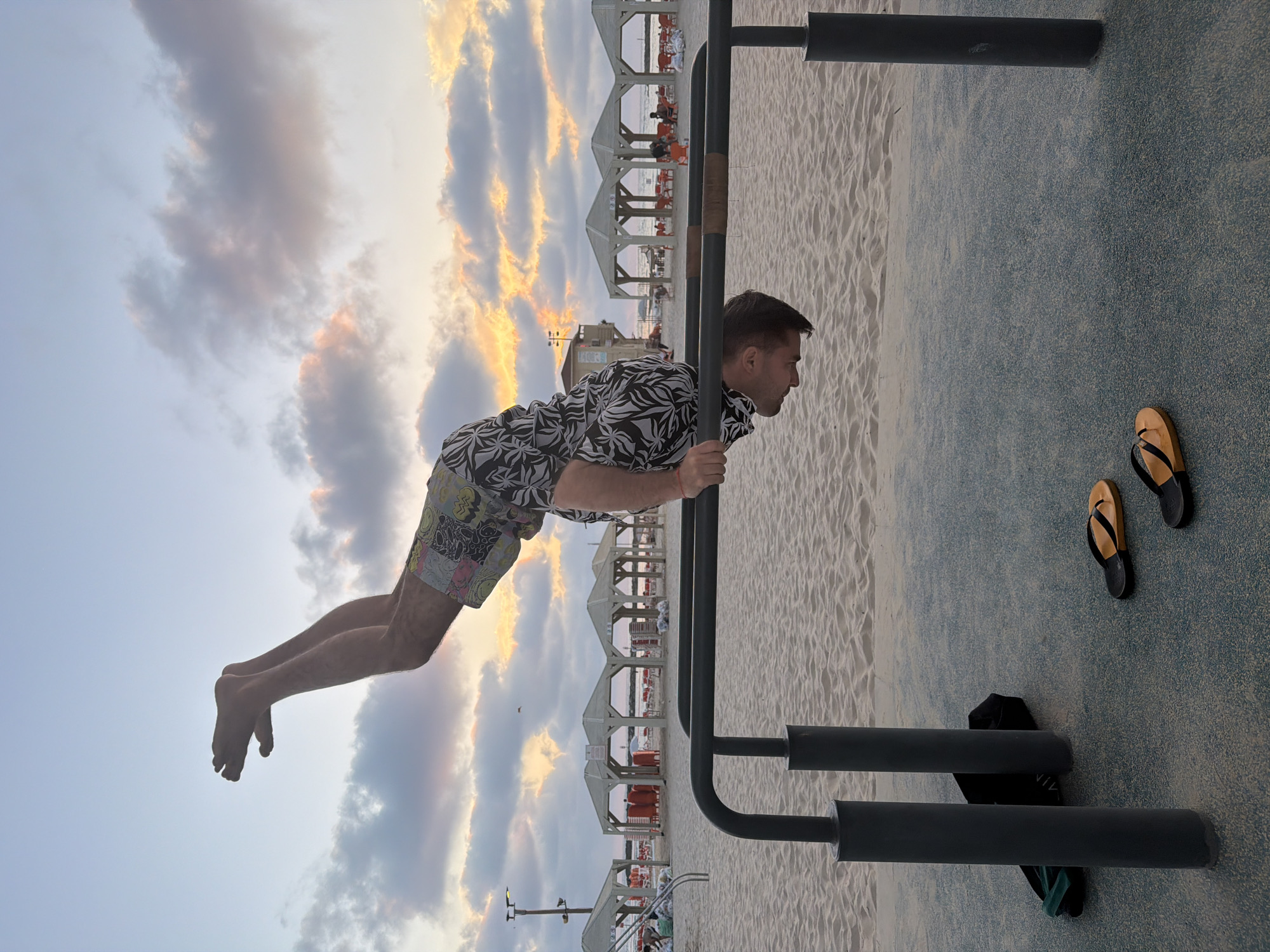 Man performs human flag exercise on Tel Aviv beach bars