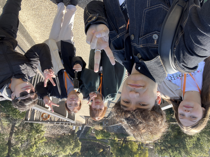Young visitors photograph Great Buddha statue at Tokai park