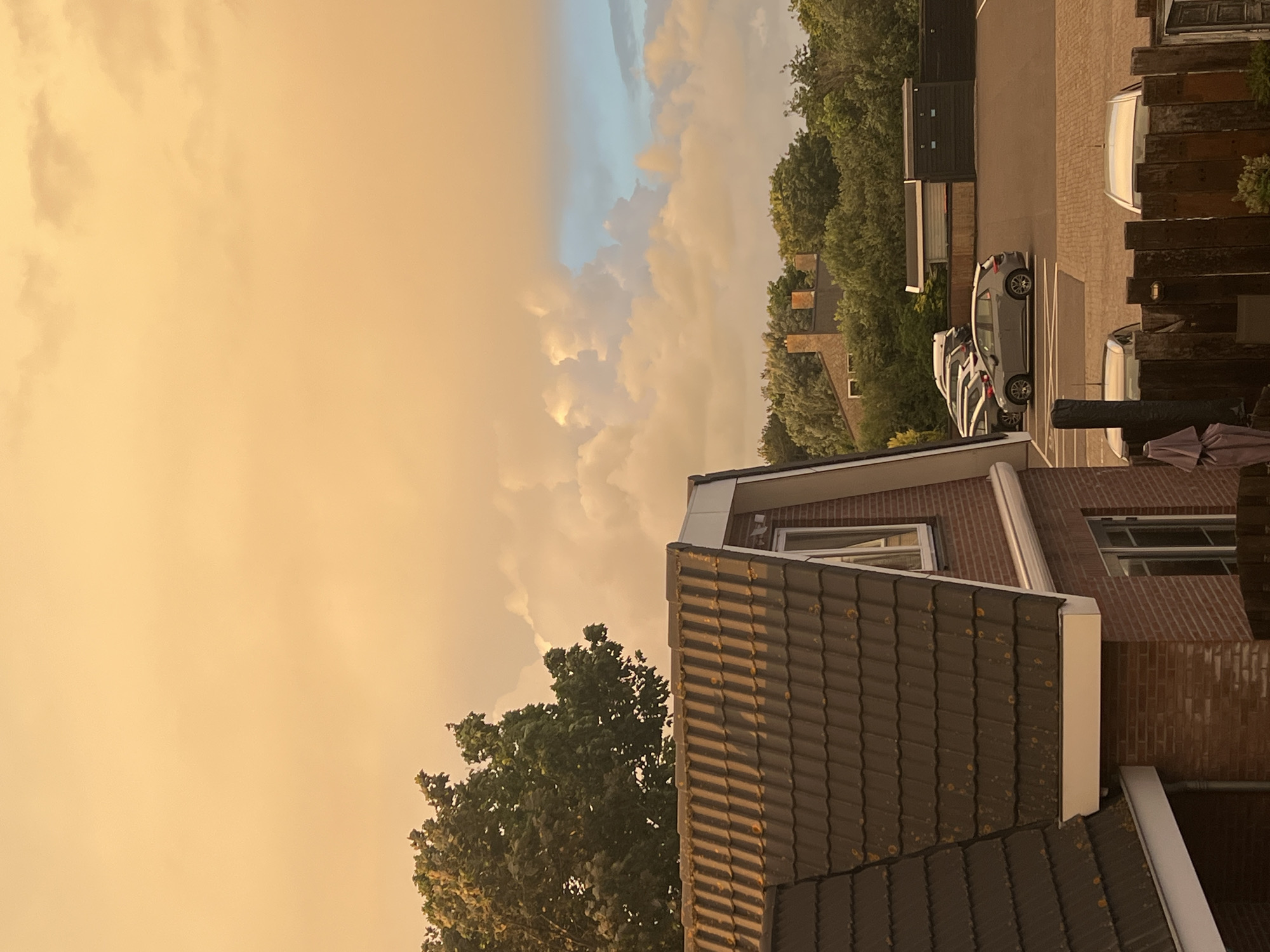 Orange-tinted sky observed over residential Petten, Netherlands