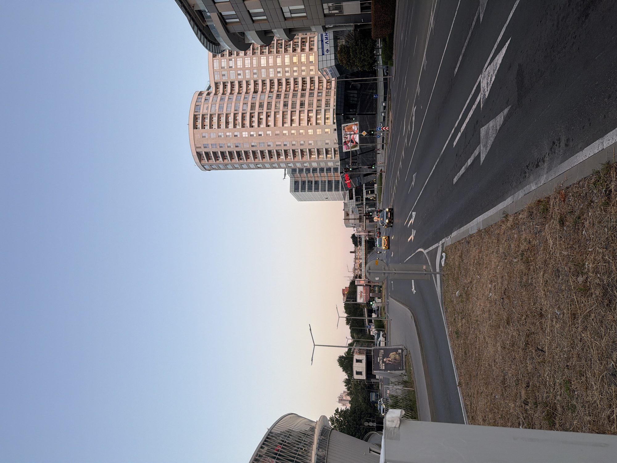 Burgas coastal boulevard at golden hour, traffic flowing both ways