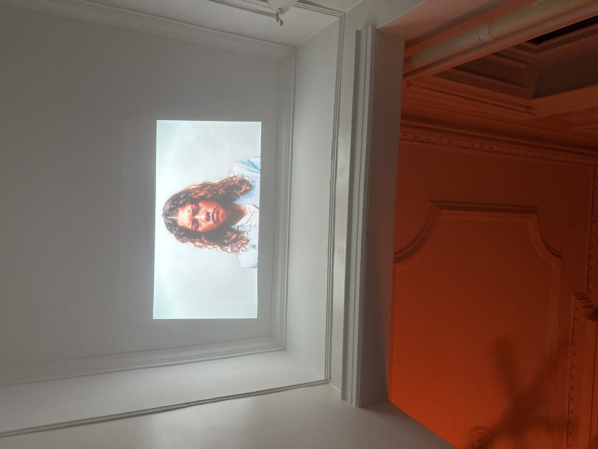Art projection featuring portraits displayed in New York interior space