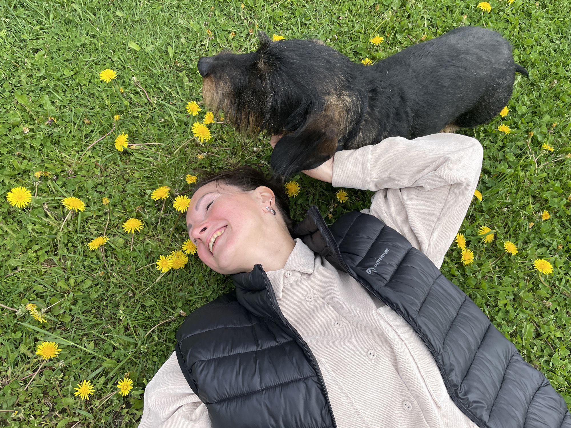 Woman and dachshund enjoy spring afternoon in Russian countryside