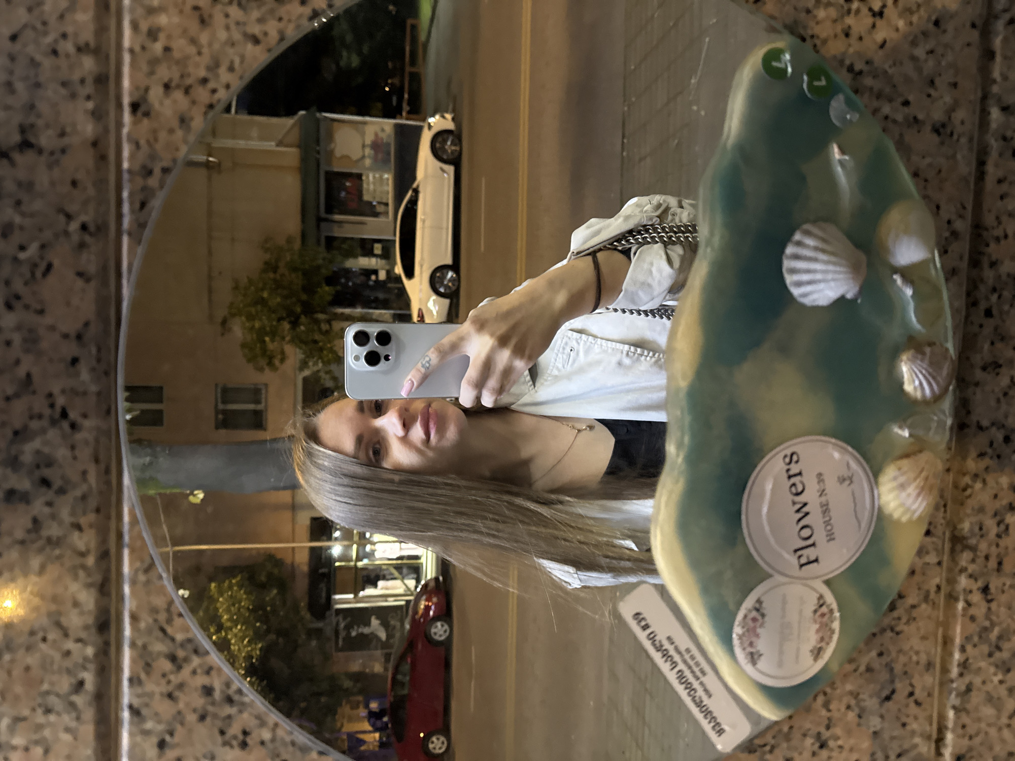 Woman takes nighttime selfie on busy Batumi street