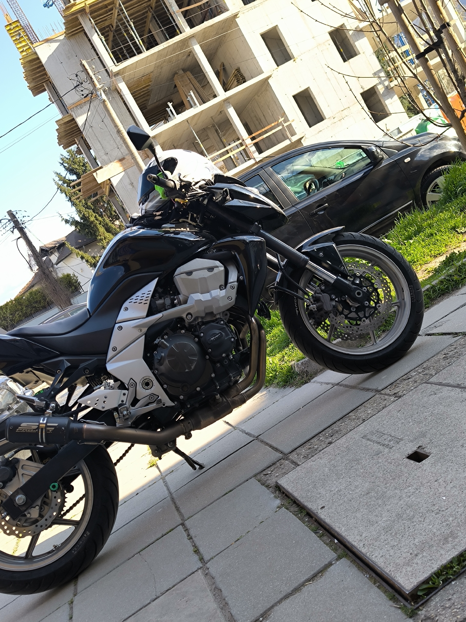 Black Kawasaki motorcycle parked on Sofia sidewalk