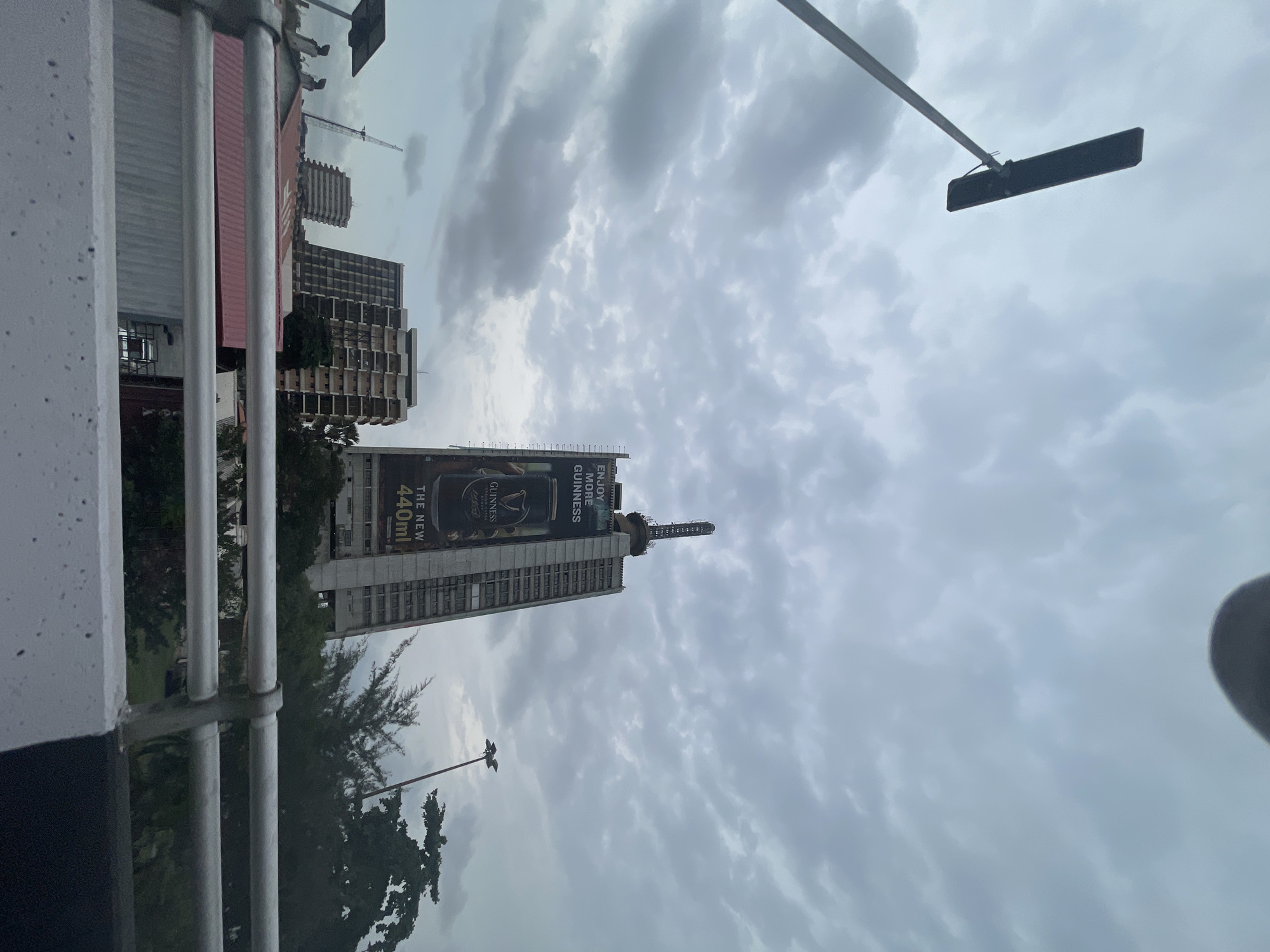 Cloudy morning skies documented over Lagos cityscape with Guinness billboard