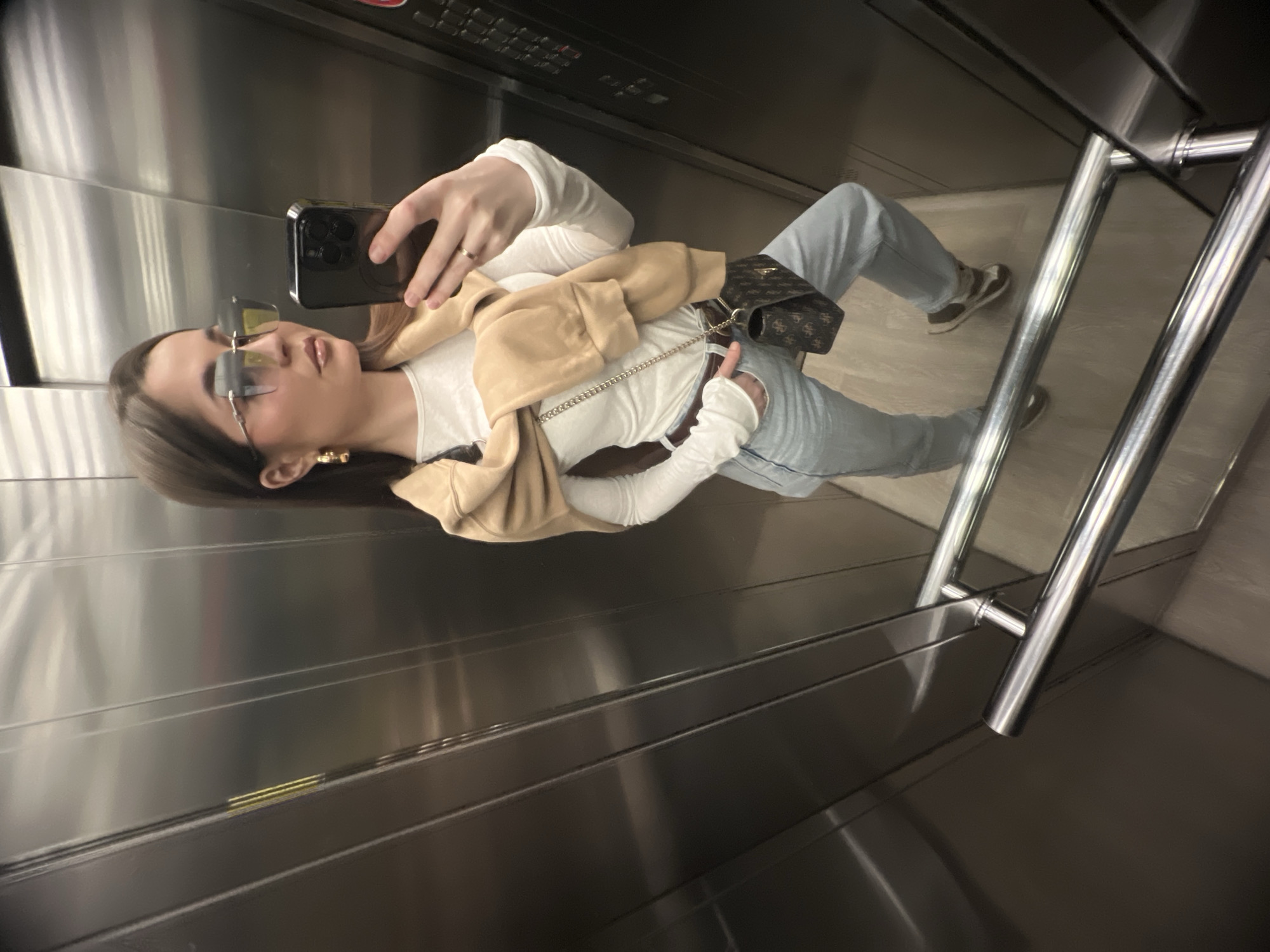 Woman Takes Selfie in Stainless Steel Elevator