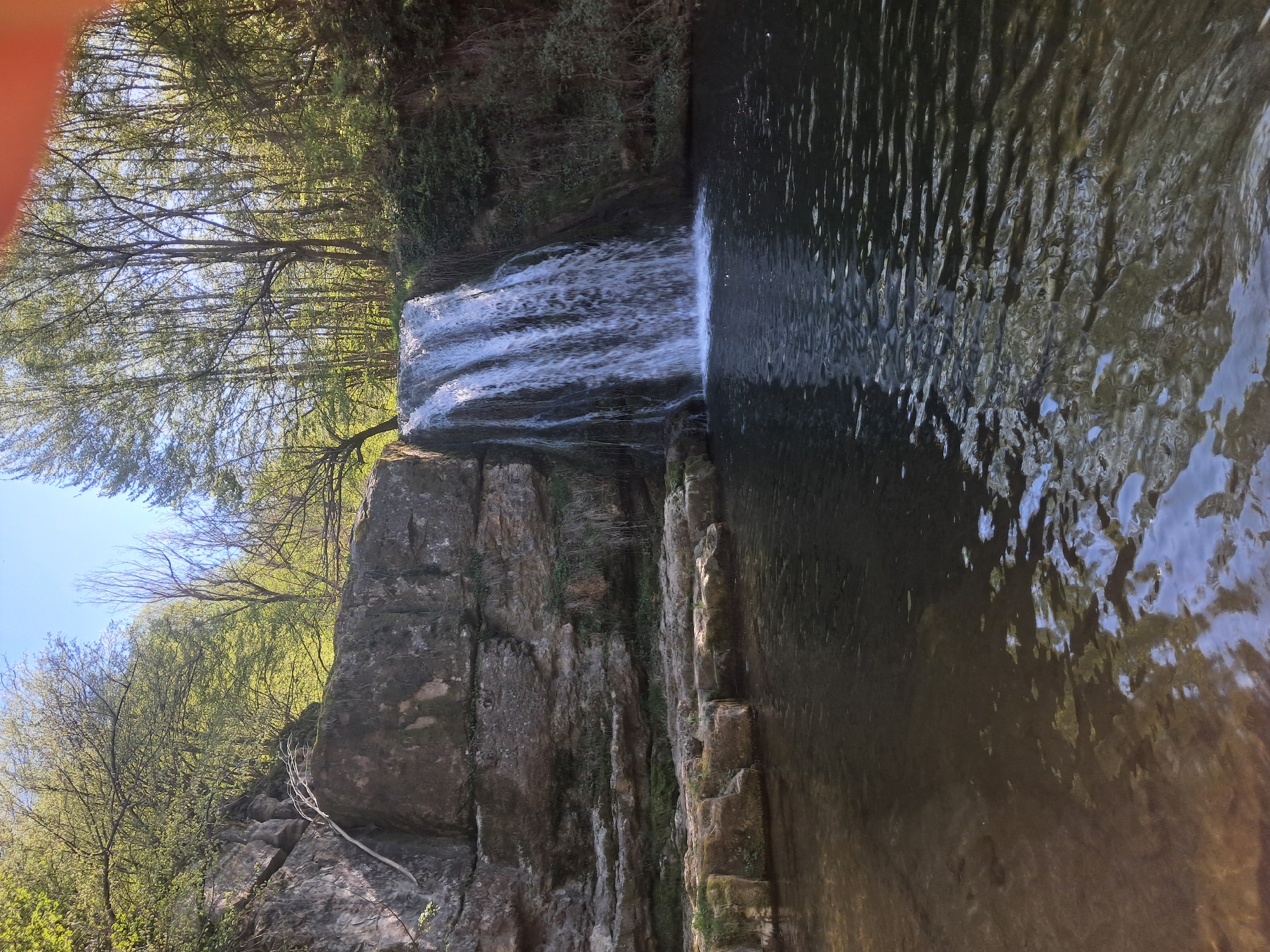 Visitor documents waterfall, wades in stream near Solari, Bulgaria