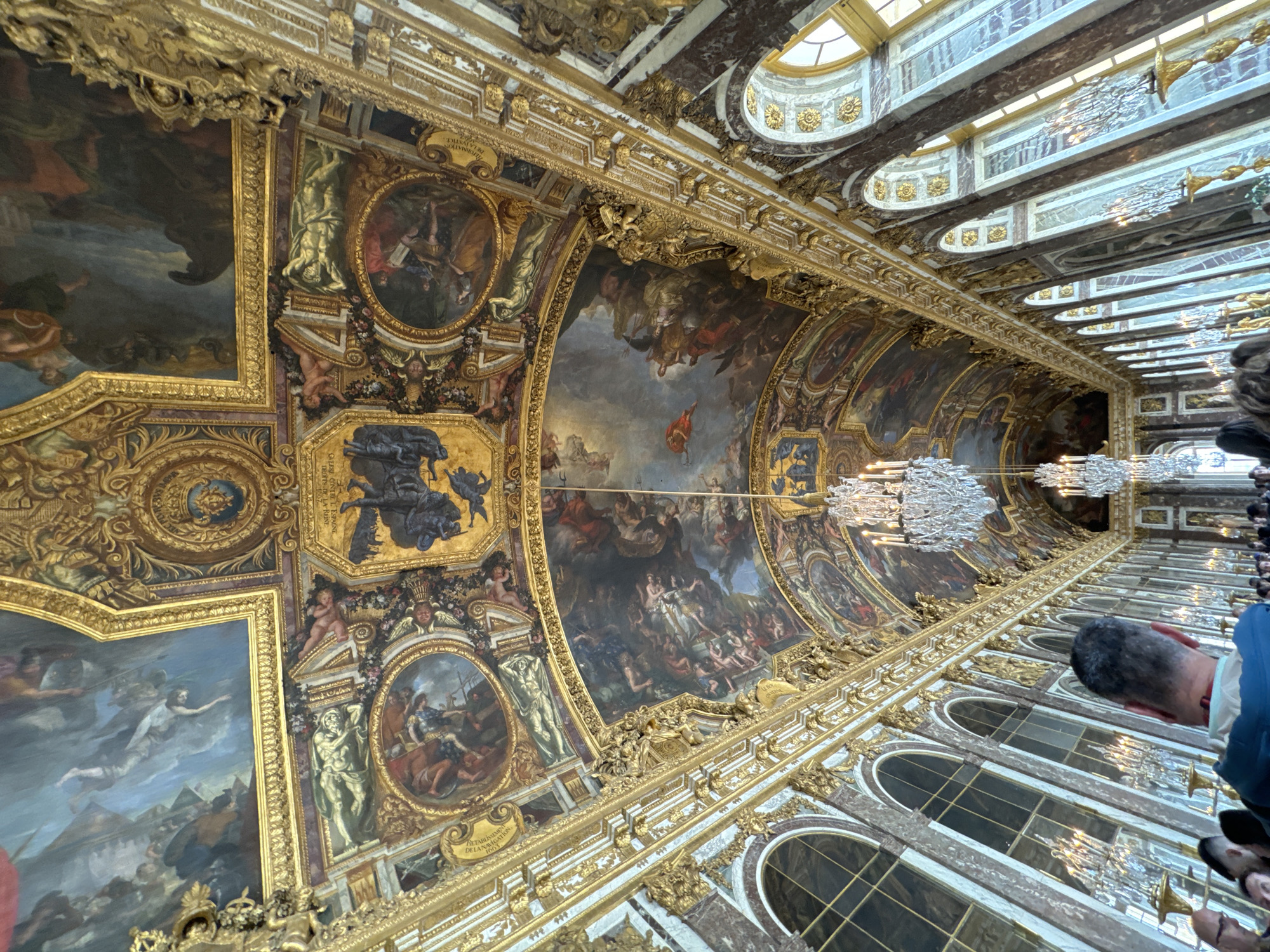 Tourist captures decorated ceiling in Versailles Hall of Mirrors
