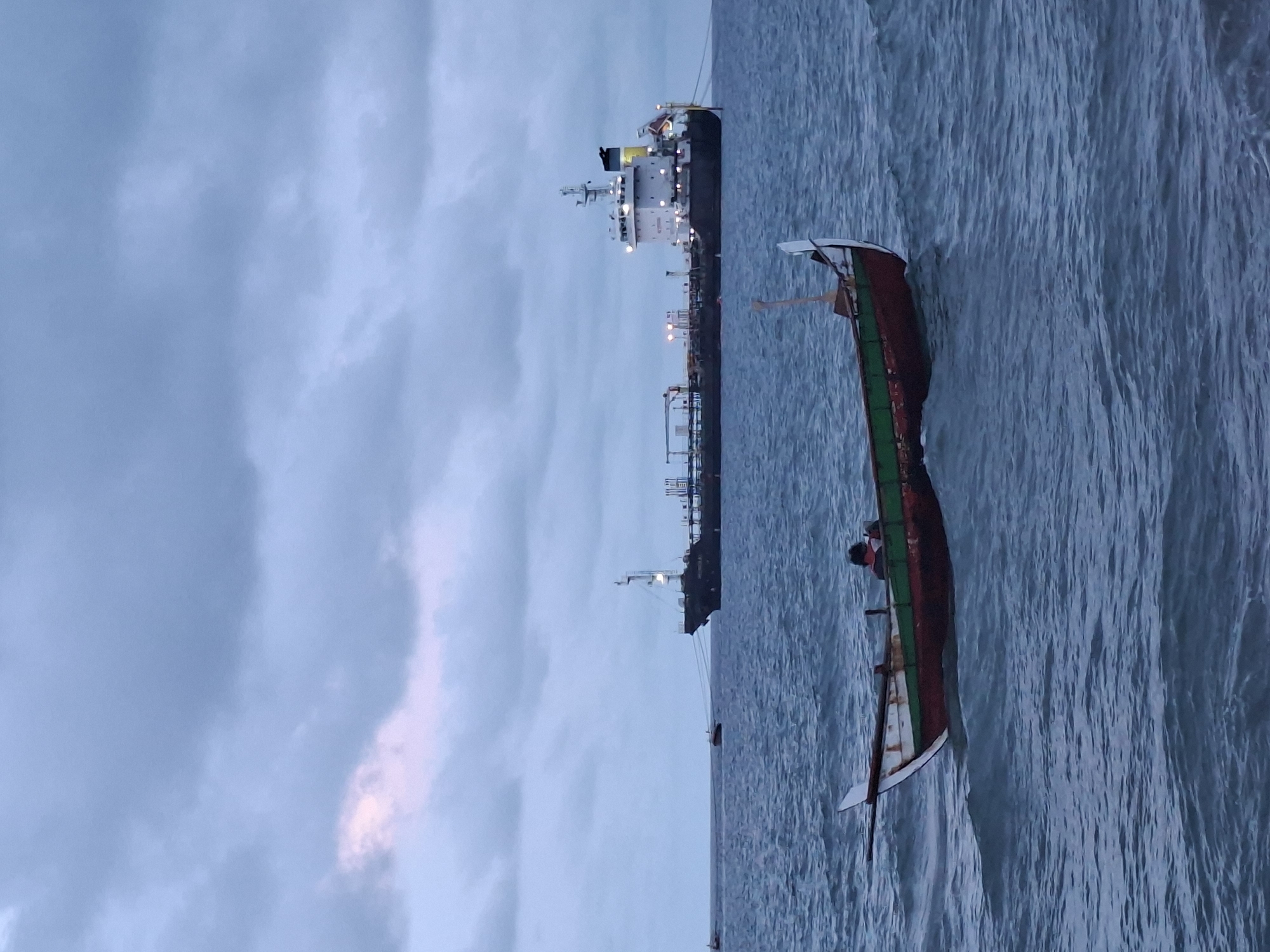 Fishing boats operate near docked tanker in Lhokseumawe port
